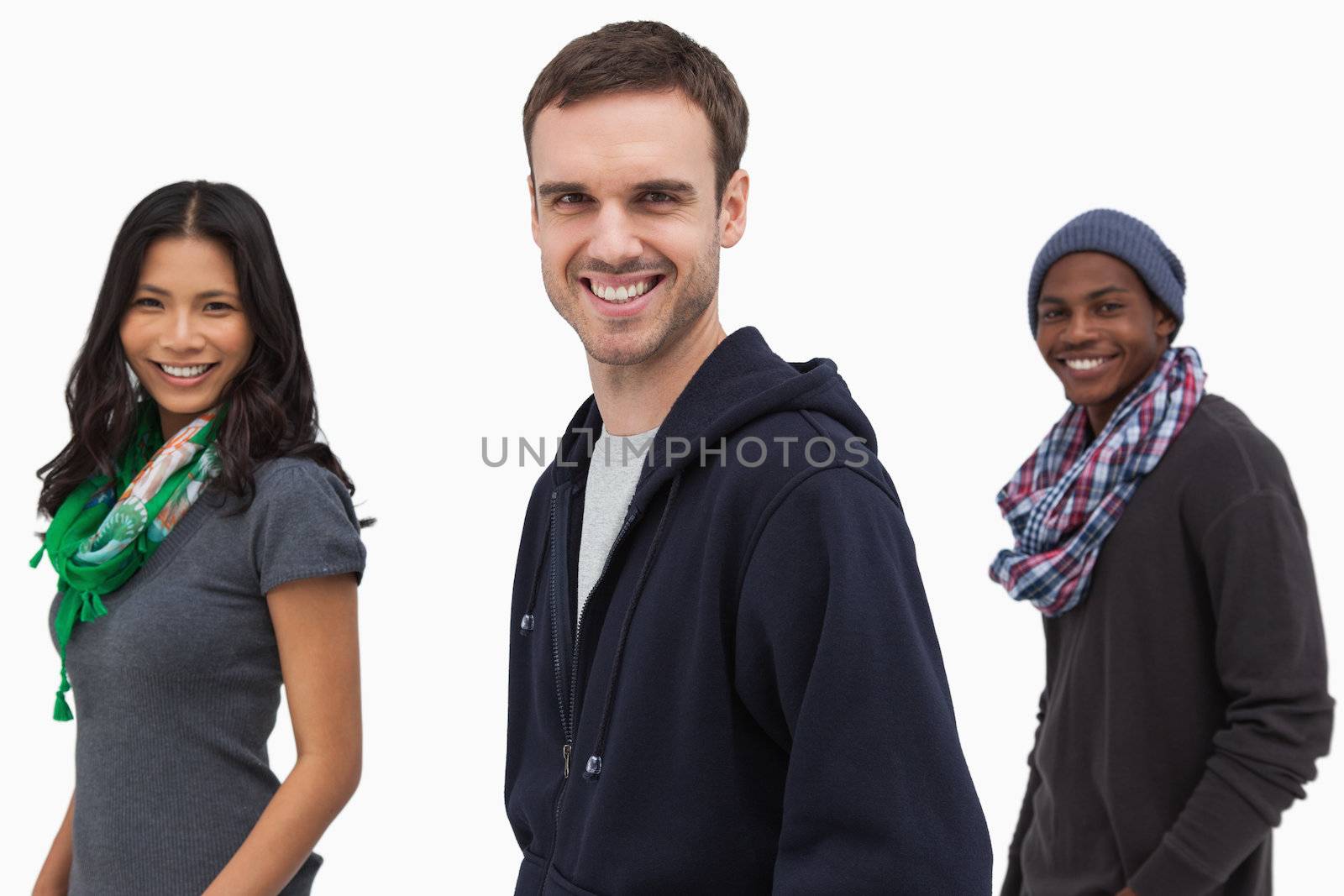 Happy stylish young people in a line on white background