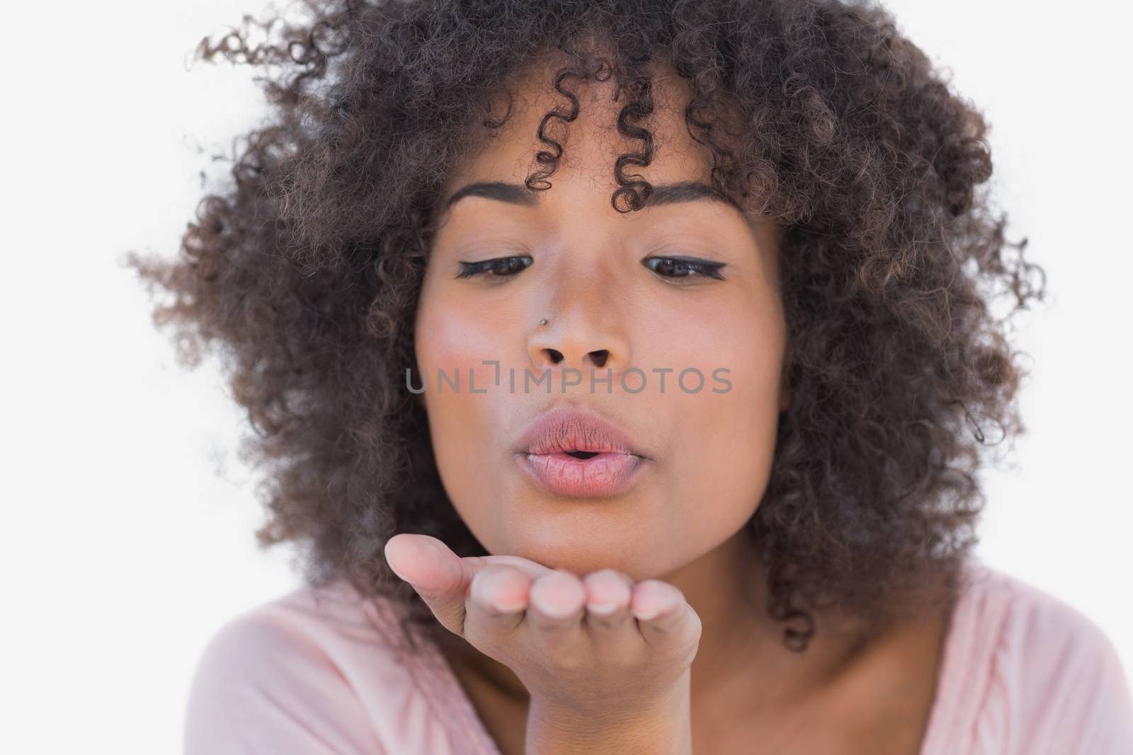 Happy woman blowing a kiss on white background