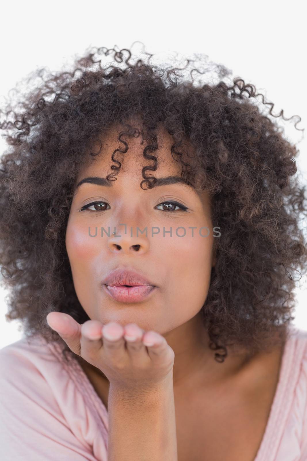 Beautiful woman blowing a kiss on white background