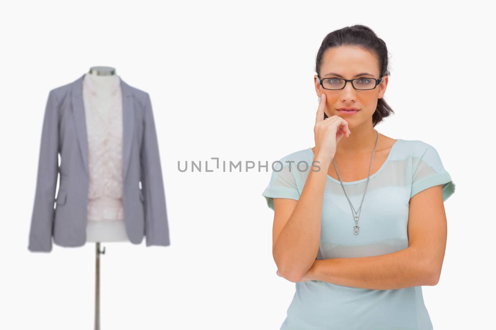 Thoughful fashion designer looking at camera on white background
