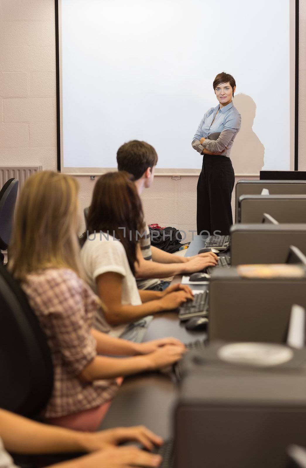 Teacher standing in front of projection screen  by Wavebreakmedia