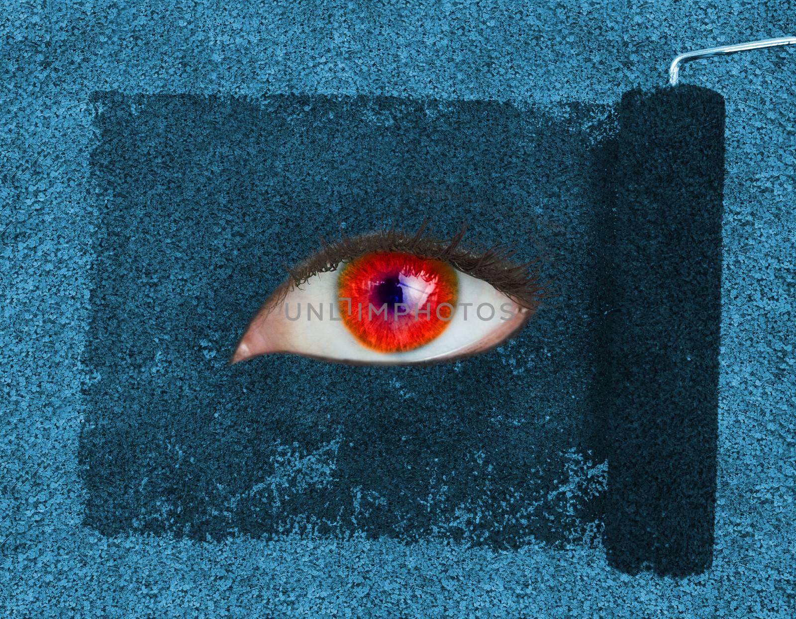 Paint roller revealing a red eye on blue texture
