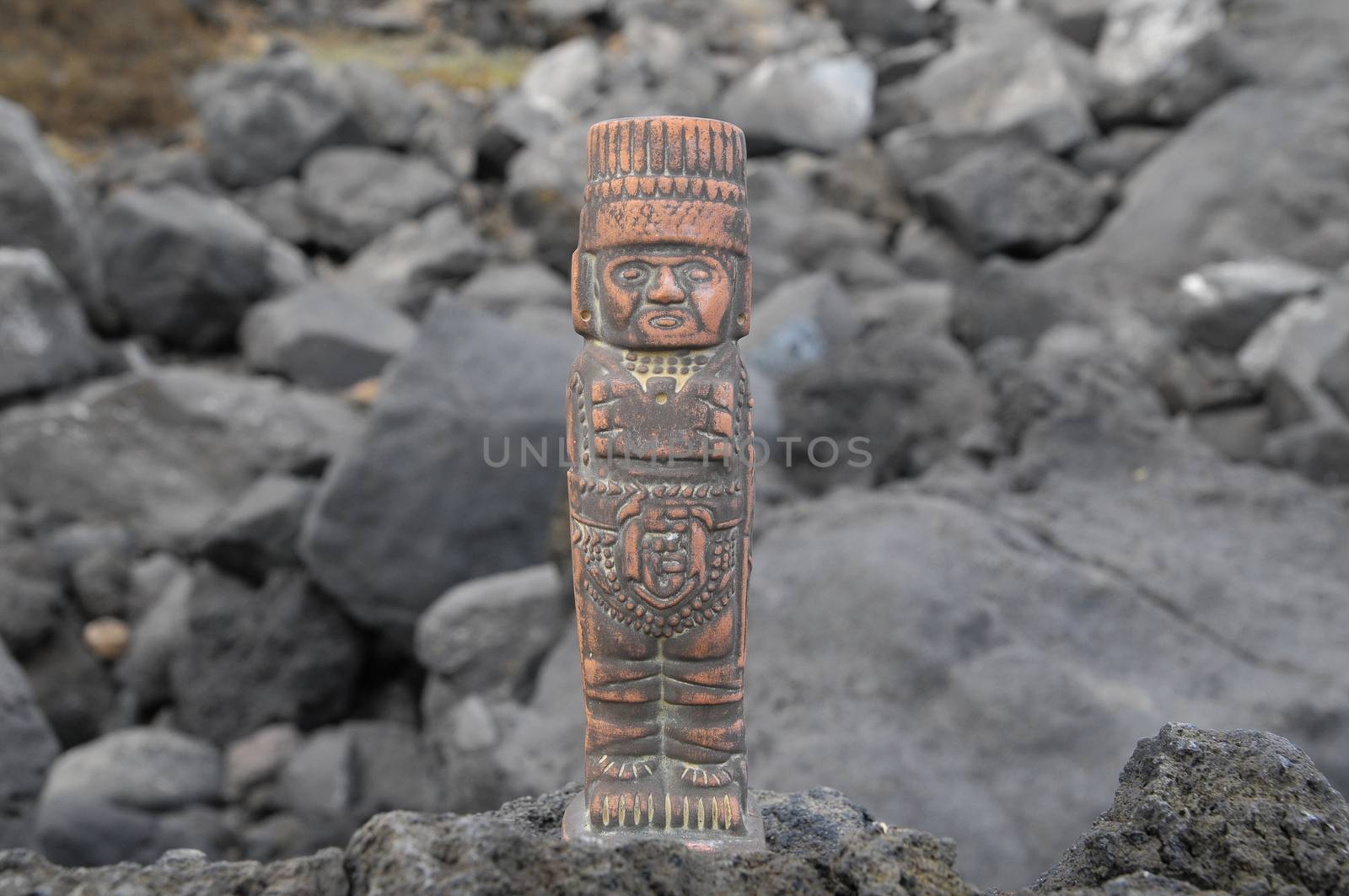 Ancient Maya Statue on the Rocks near the Ocean