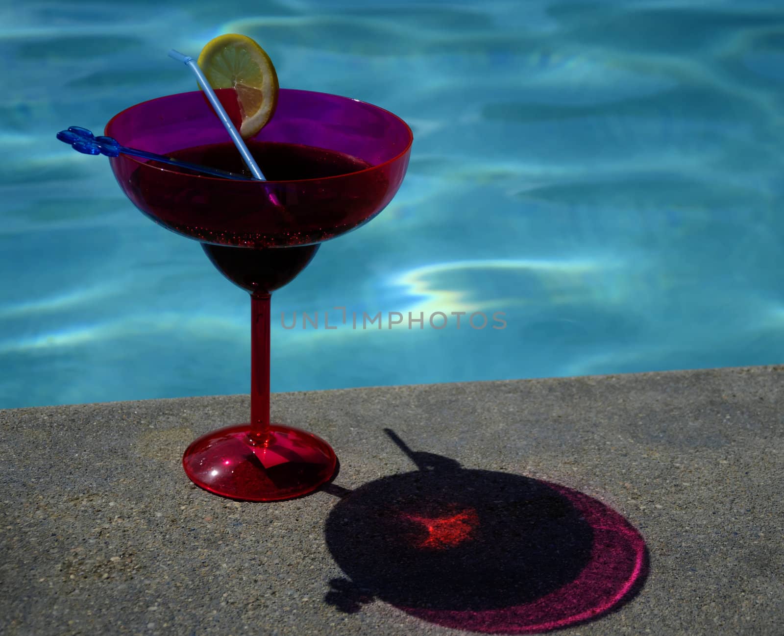 Two drinks in colour coctail glass by the swimming pool