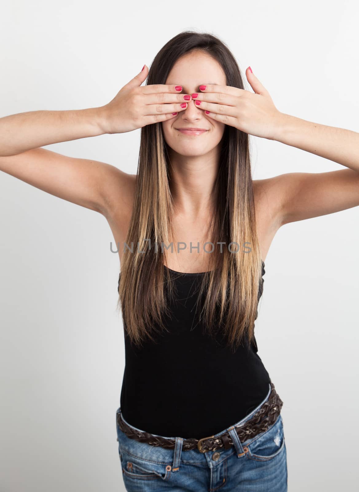 Young woman covering her eyes  by Izaphoto