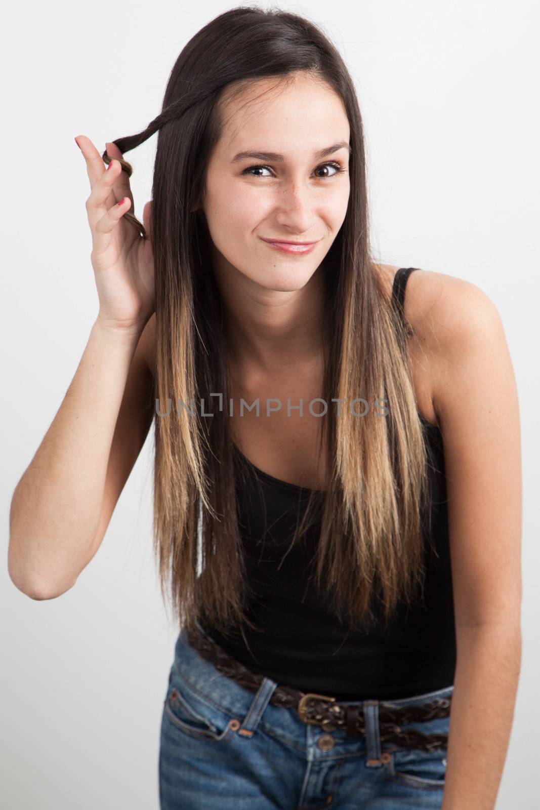 Beautifull young brunette woman twisting her hair