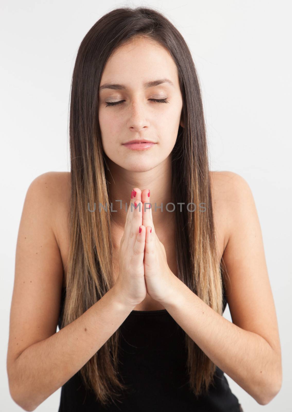 Young caucasian woman praying on with background