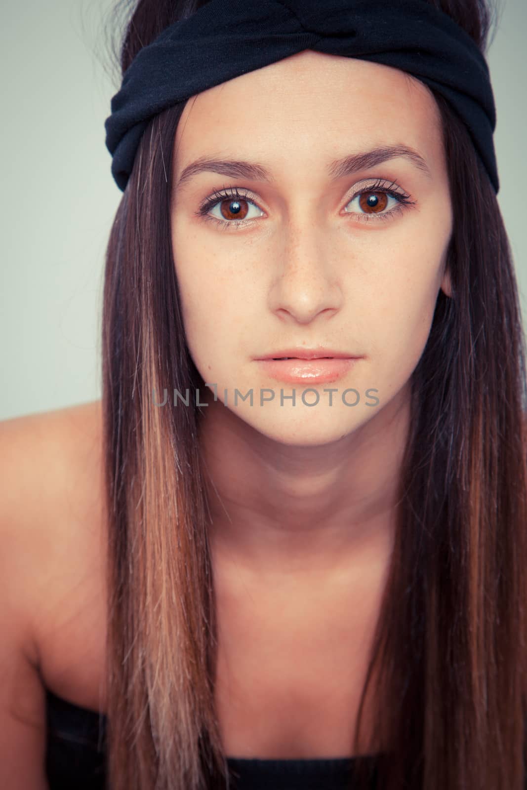 Young brunette woman posing with black haed-band