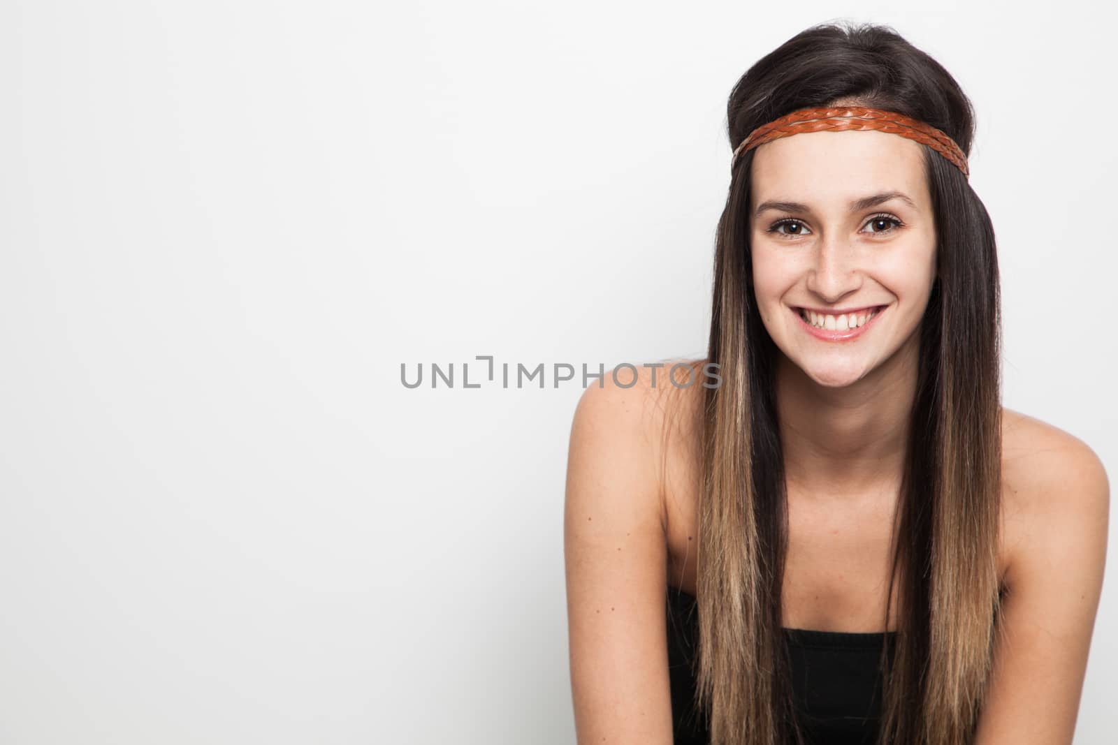 Young brunette woman posing with brown leather haed-band