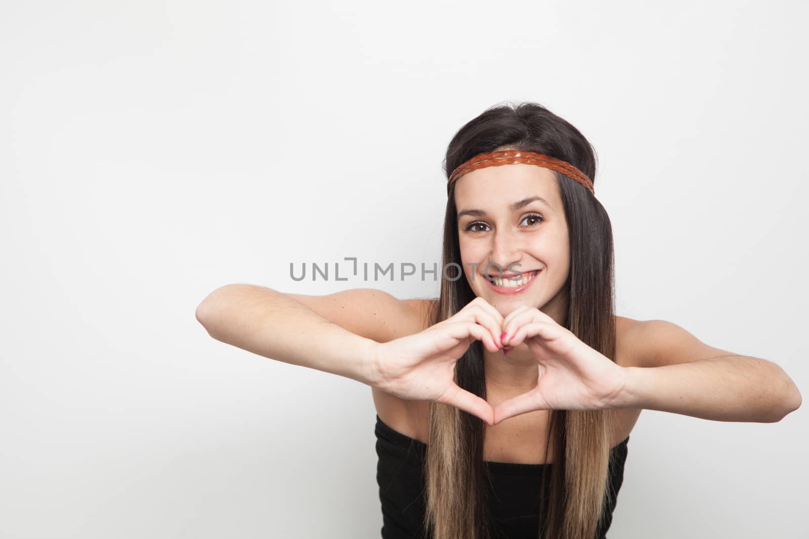 Young woman posing on a white background doing a heart by Izaphoto