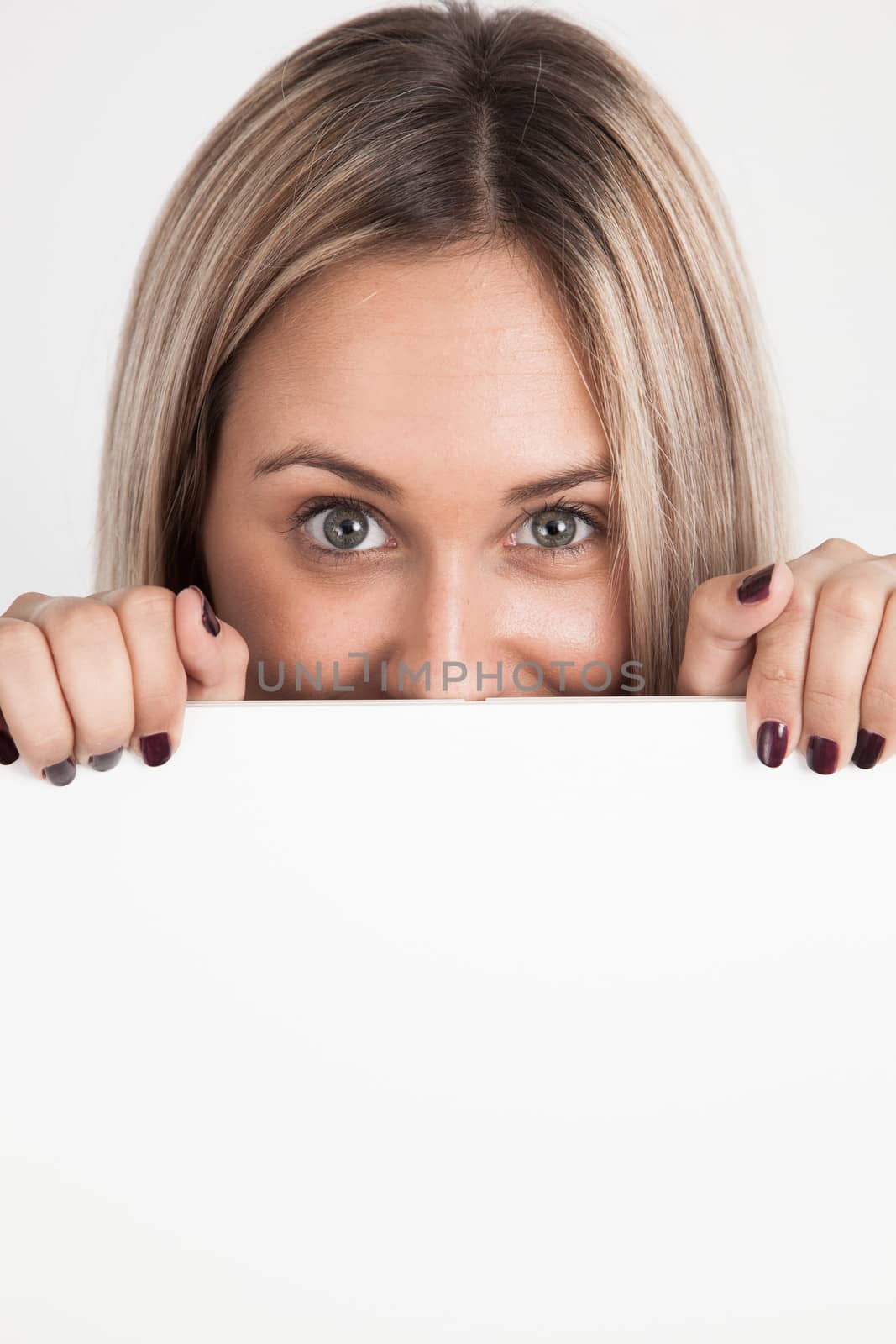 Young blond woman holding a white board