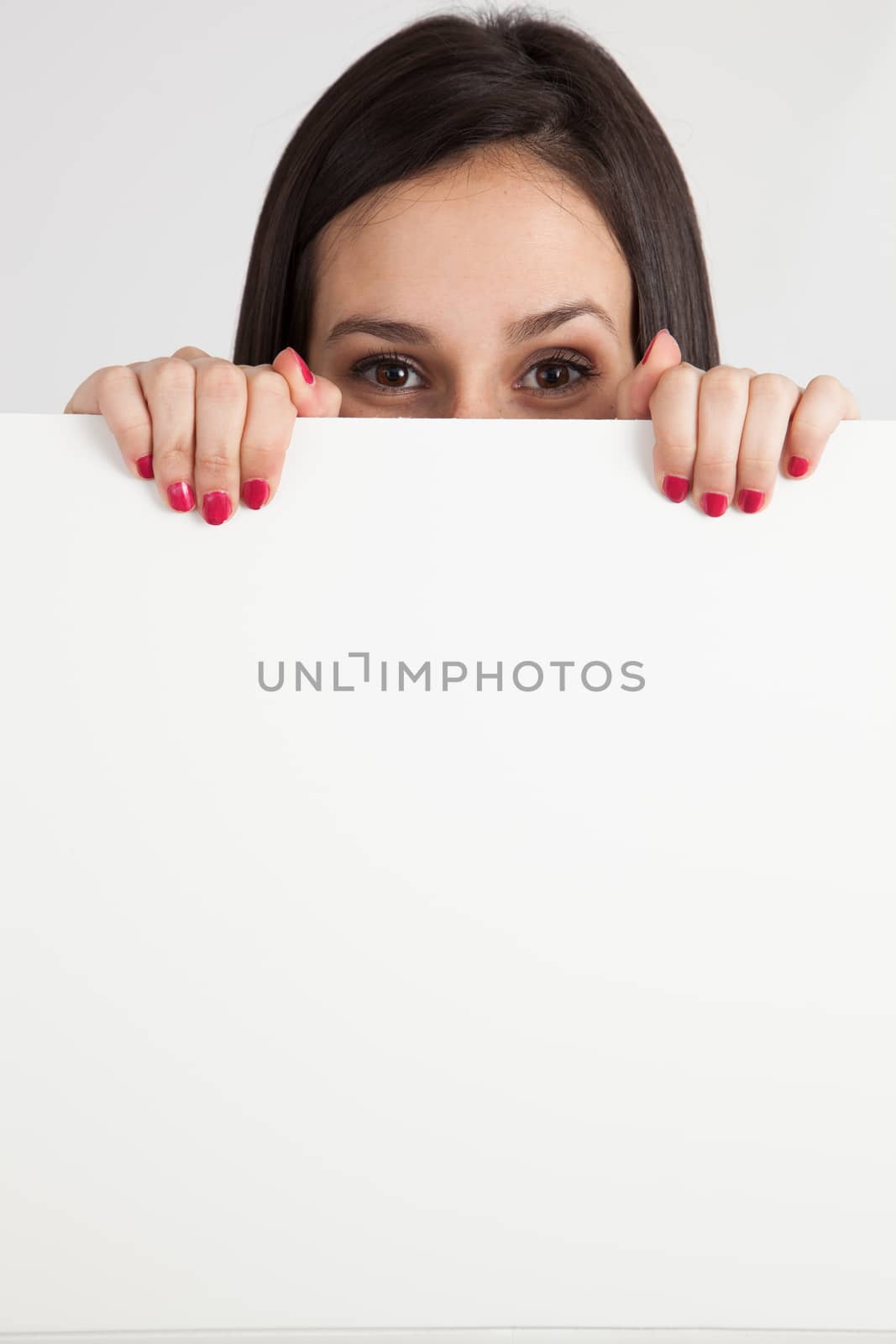 Young brunette woman holding a white board