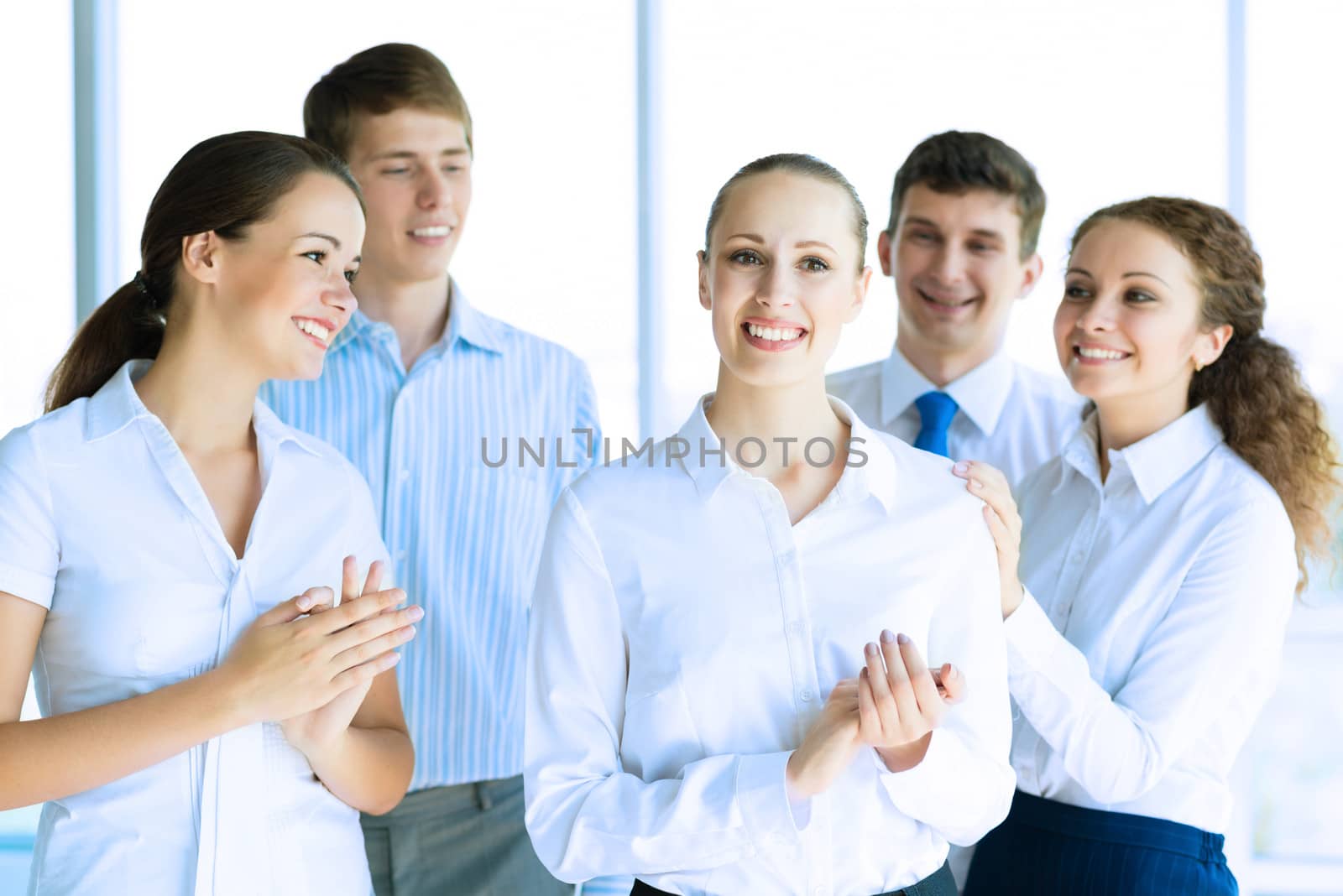 Successful business woman receiving congratulations from his colleagues, business success