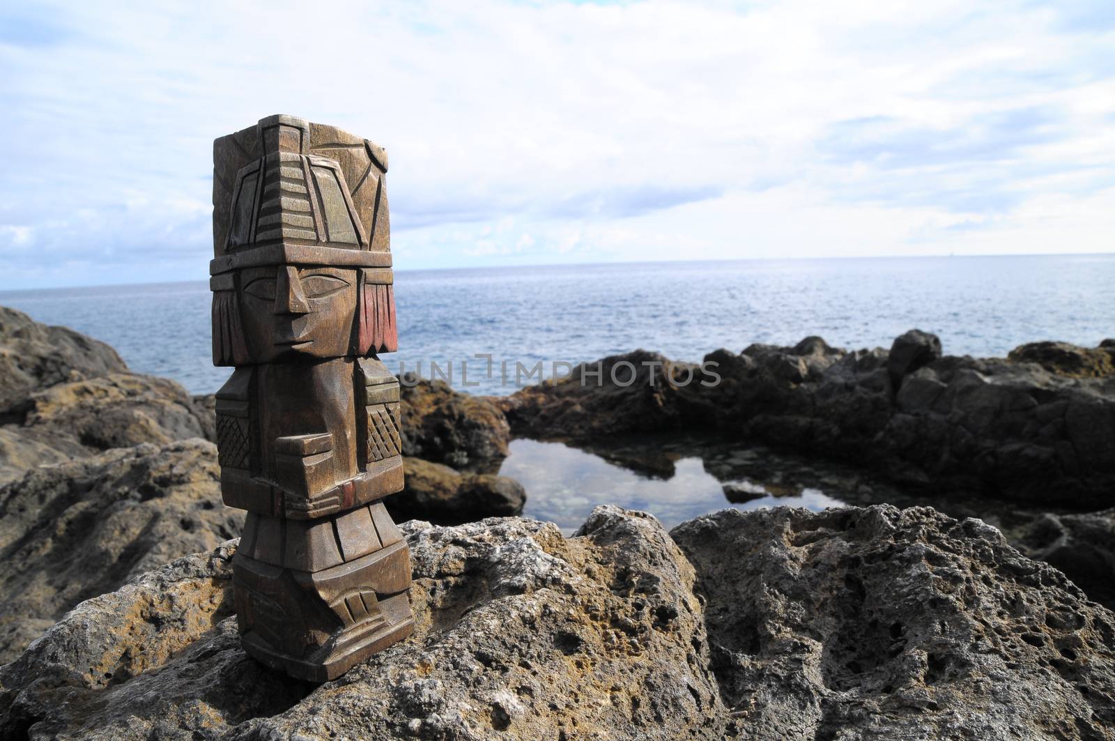 Ancient Maya Statue on the Rocks near the Ocean