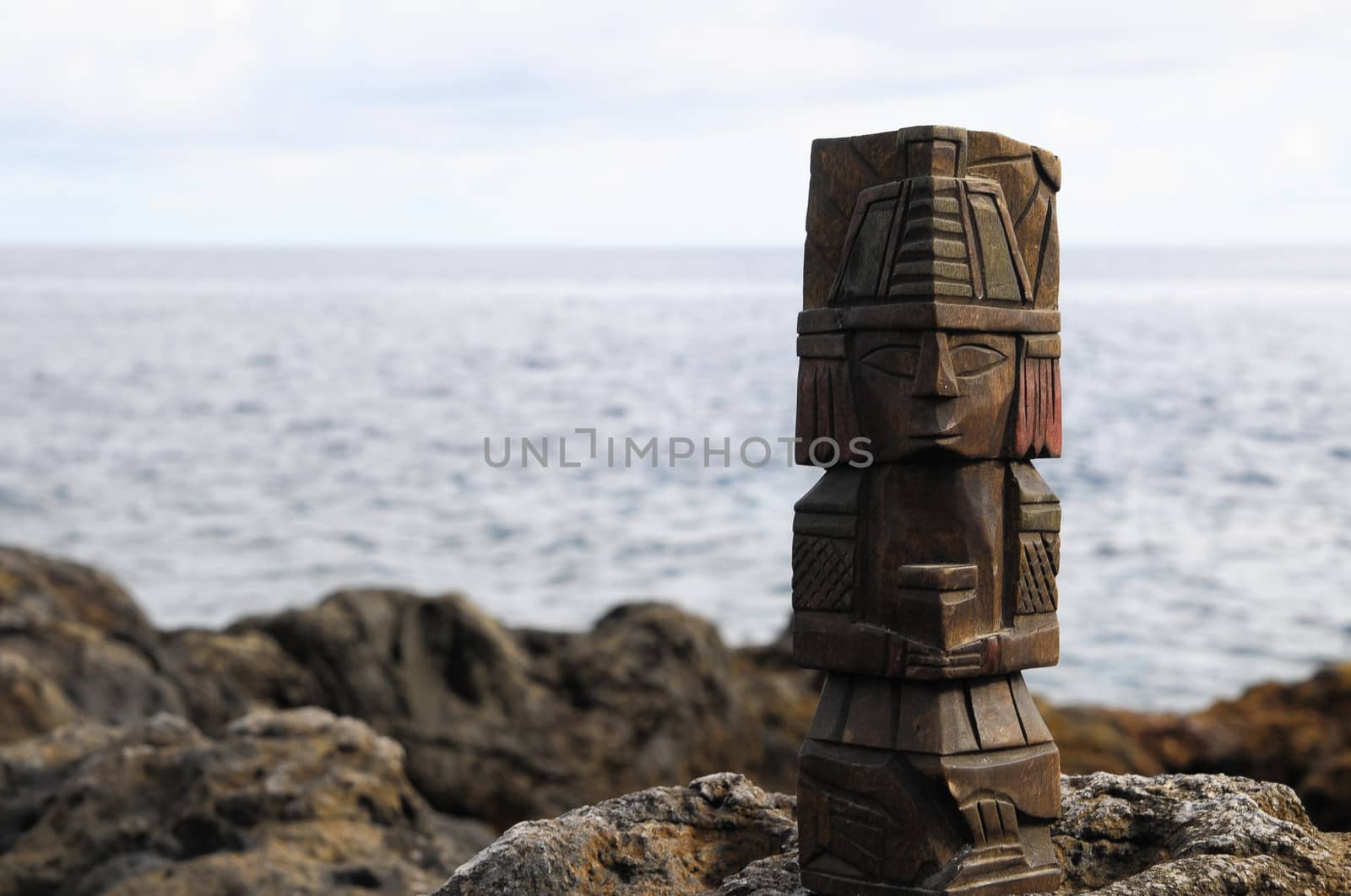 Ancient Maya Statue on the Rocks near the Ocean