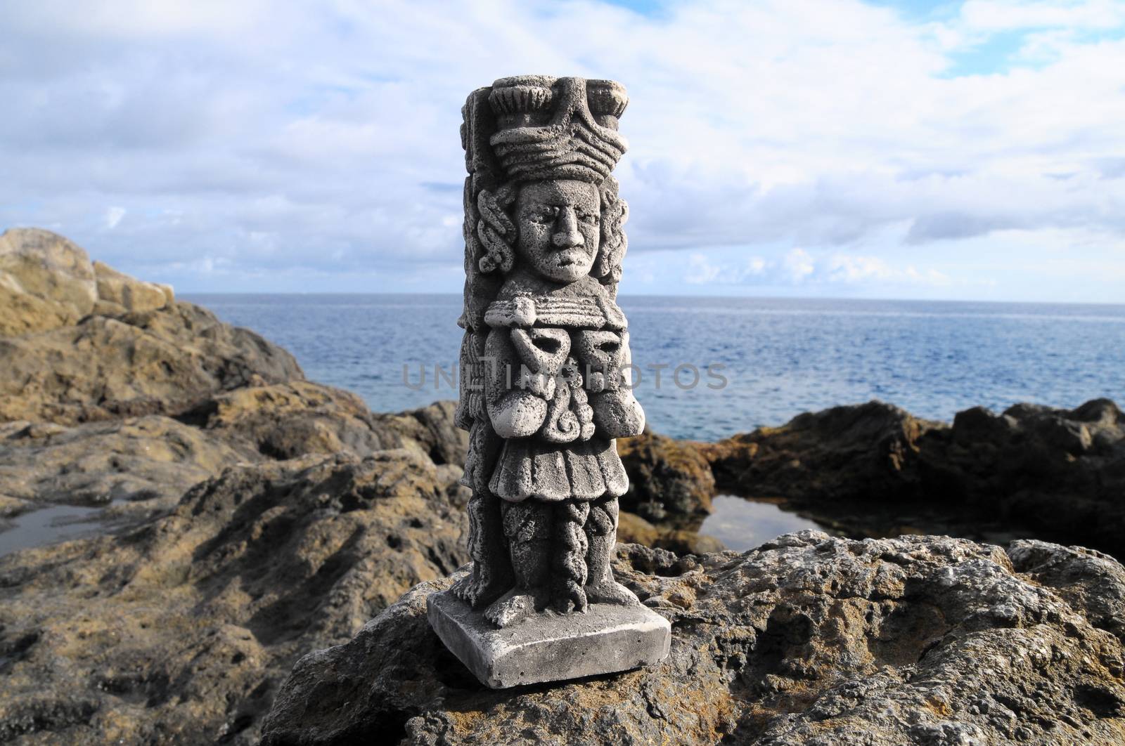 Ancient Maya Statue on the Rocks near the Ocean