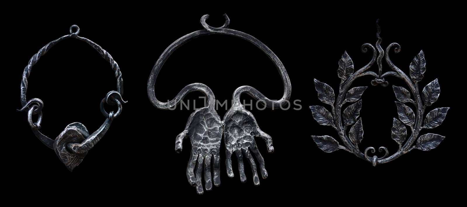 Three decorative forged metal pendants rings isolated on a black by pt-home