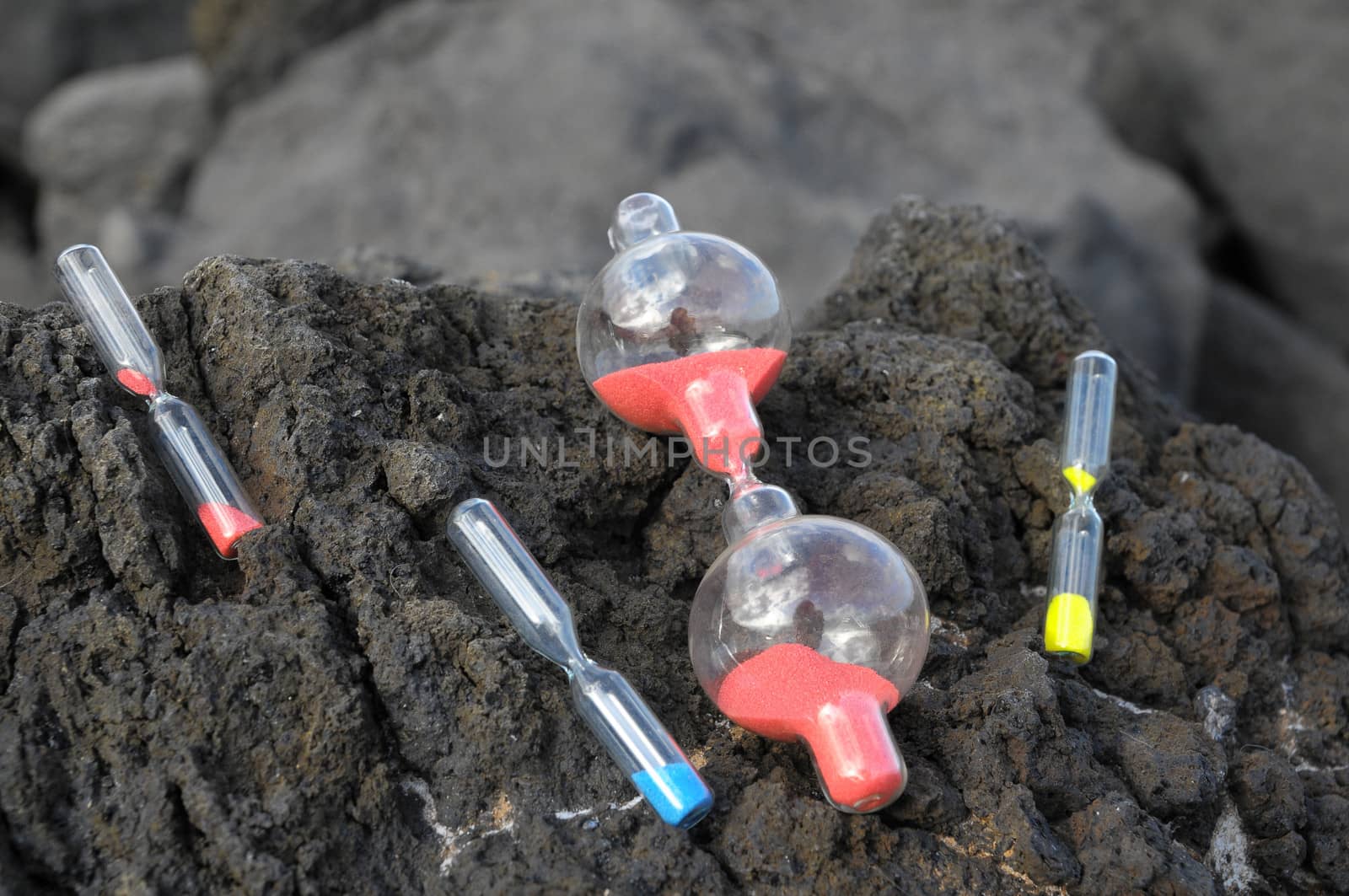 Time Concept - Hourglass Abandoned on the Volcanic Rocks