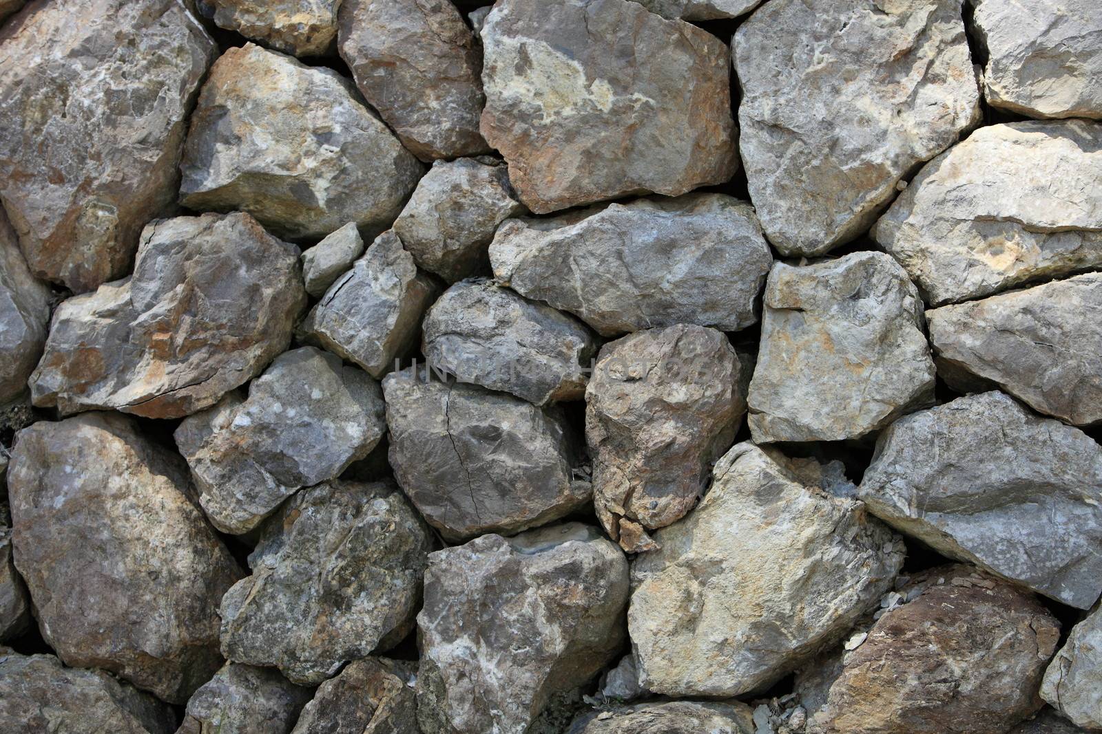 Background showing dry stone rock construction where rocks are interlocked using their natural shape for stability without using mortar
