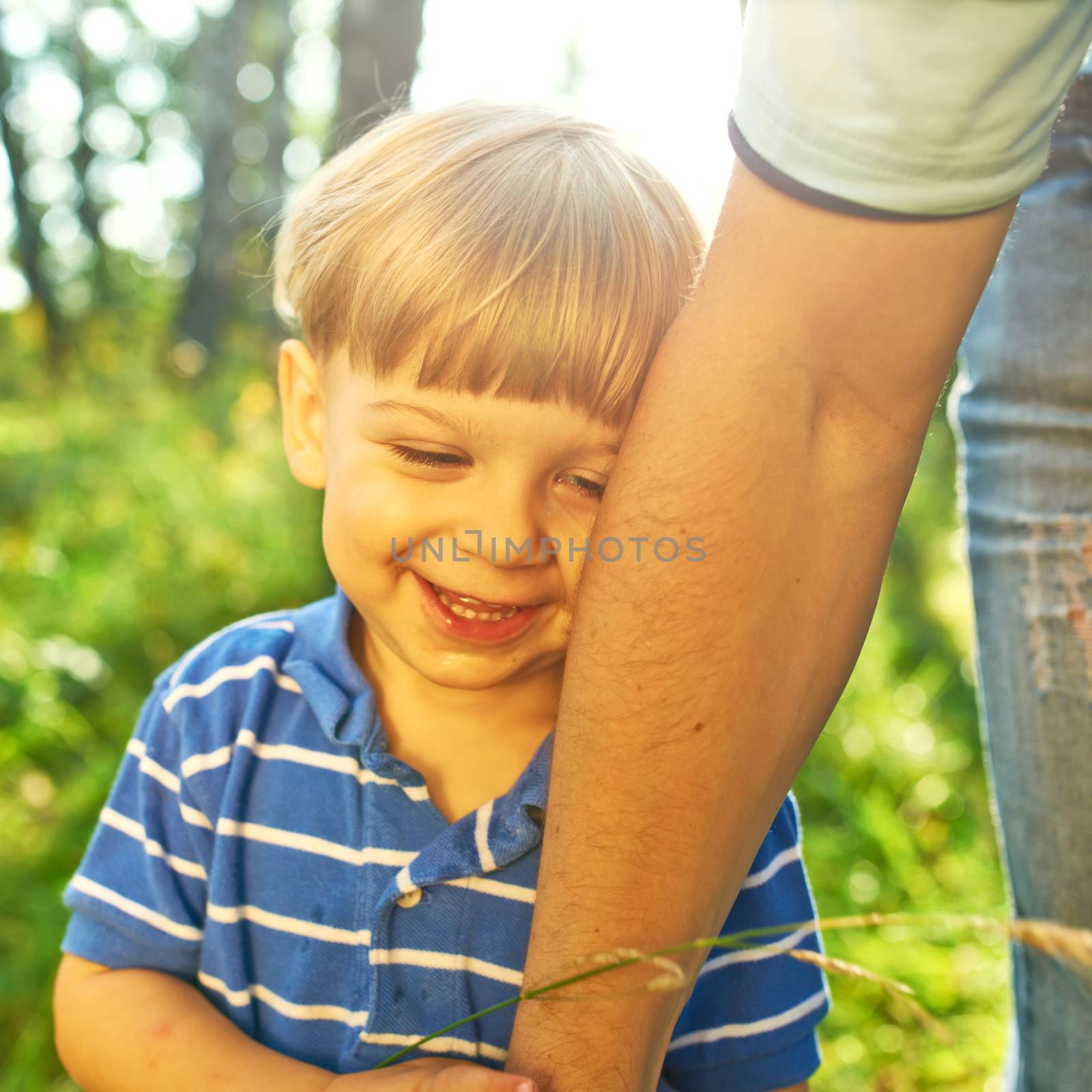 Smiling boy holding father's hand
