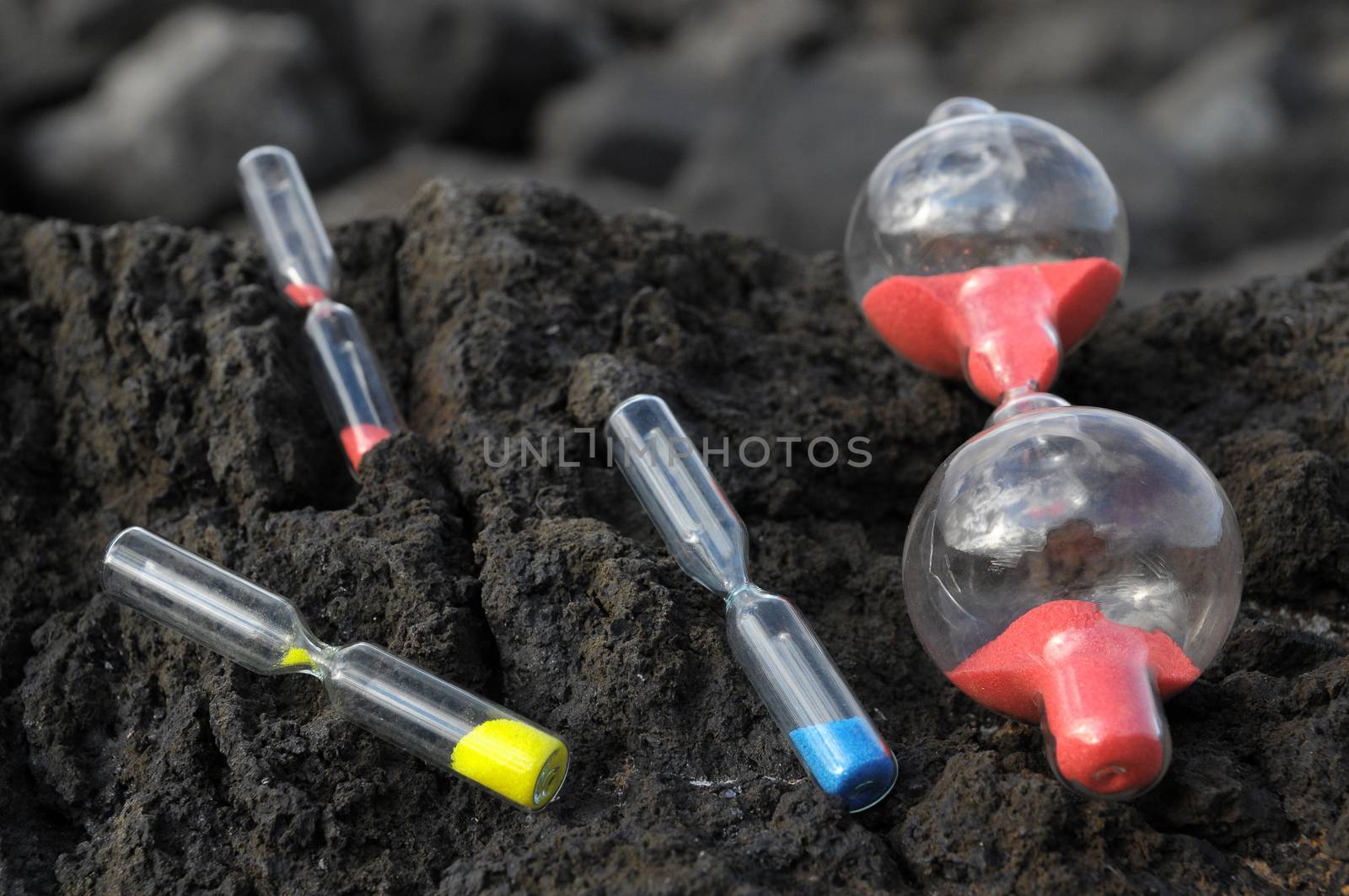 Time Concept - Hourglass Abandoned on the Volcanic Rocks