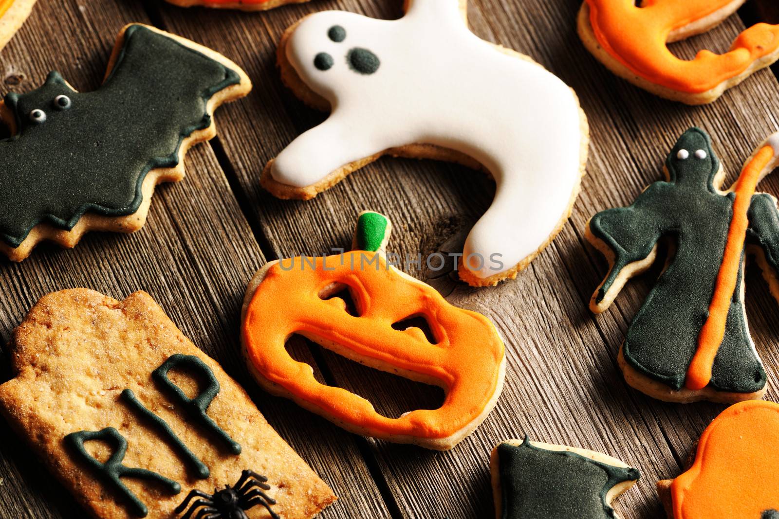 Halloween homemade gingerbread cookies over wooden table