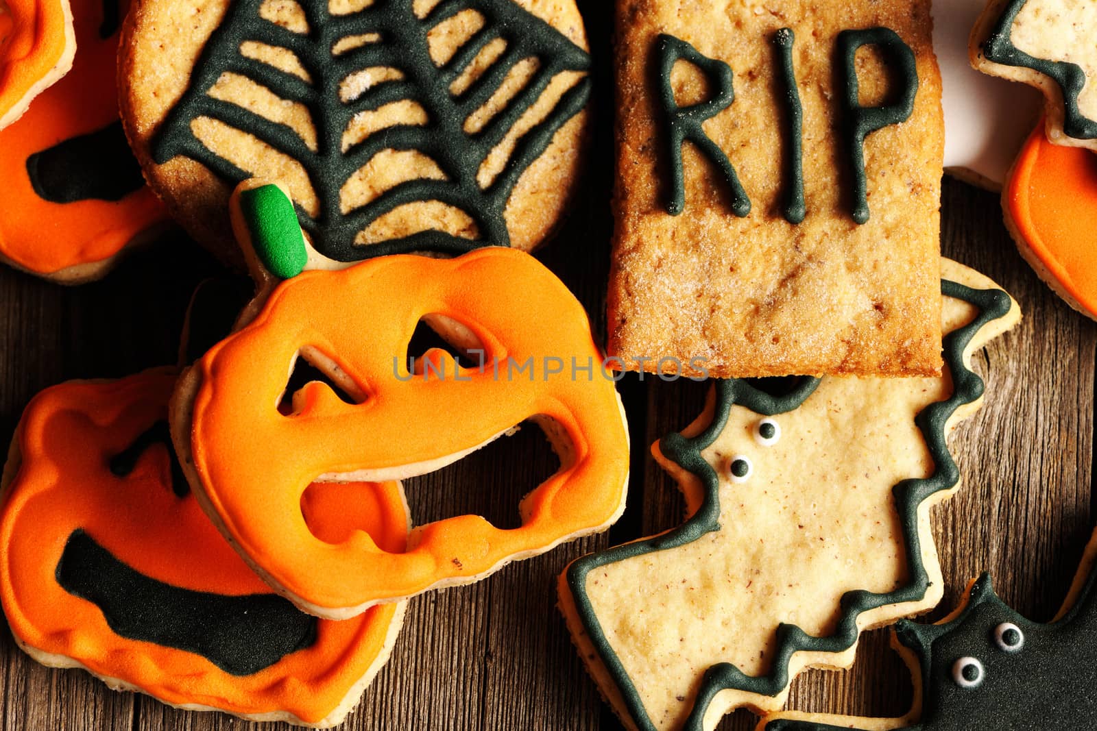 Halloween homemade gingerbread cookies over wooden table