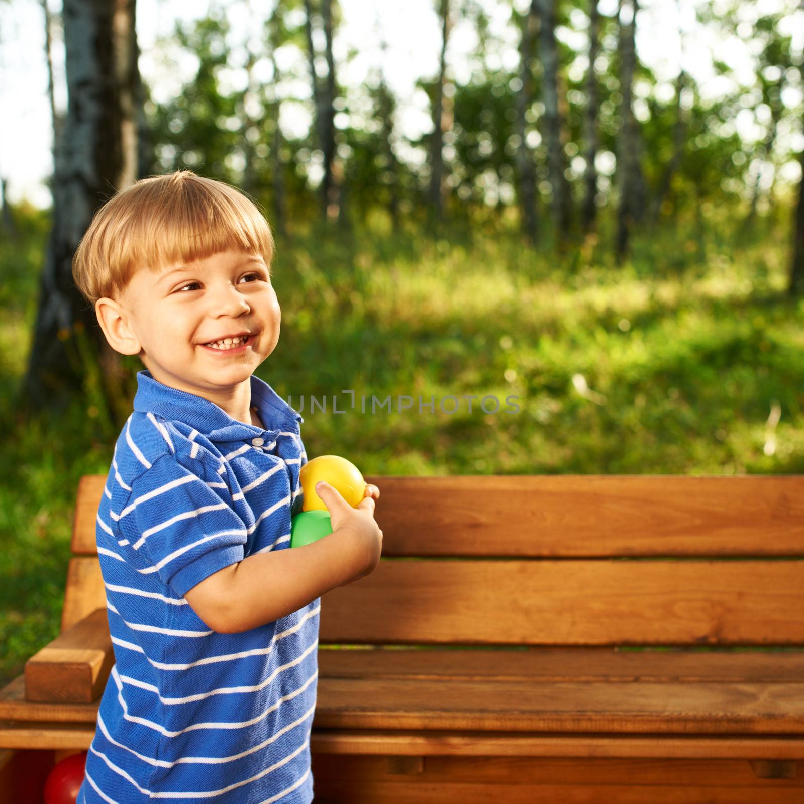 Happy child playing at colorful plastic balls playground high view