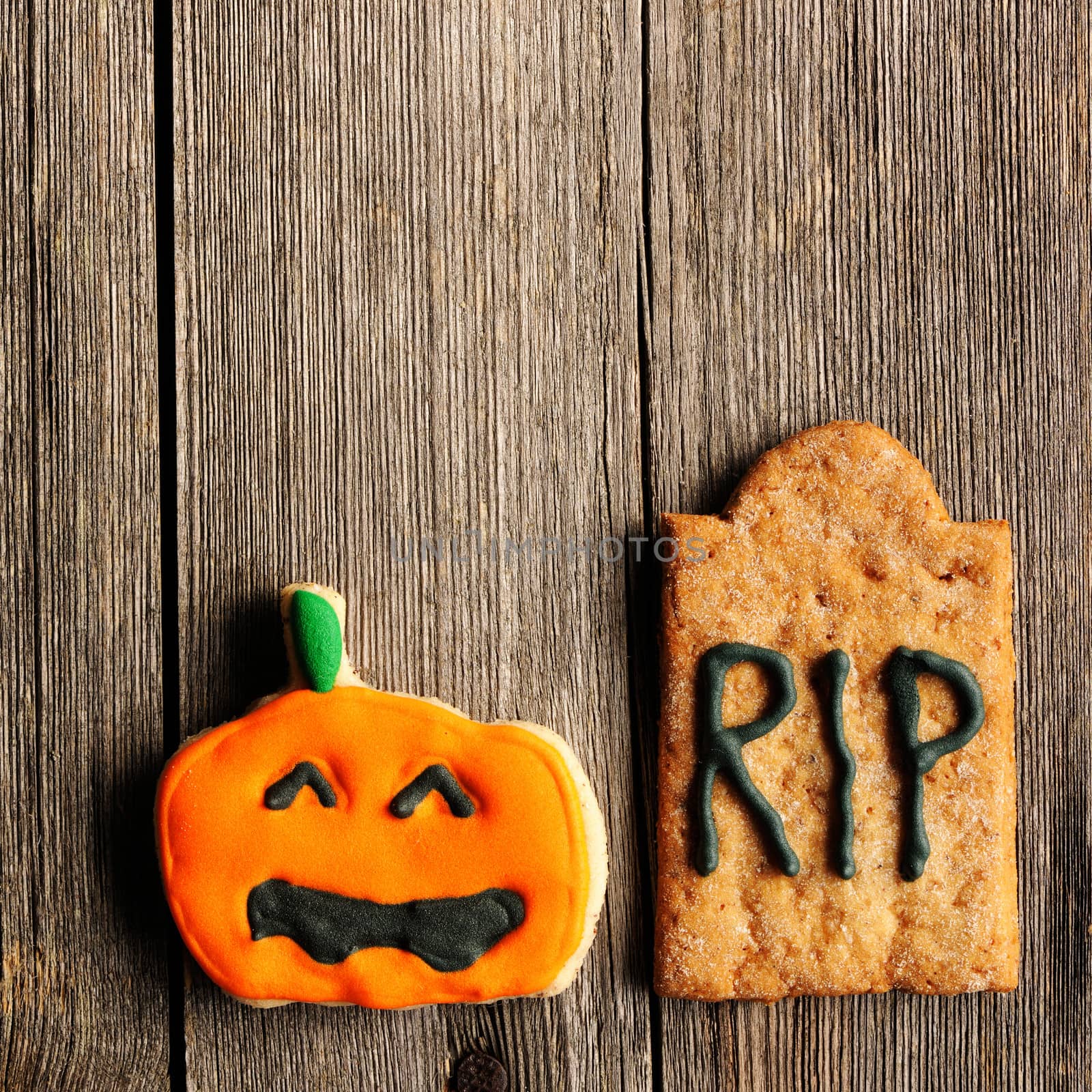 Halloween homemade gingerbread cookies over wooden table