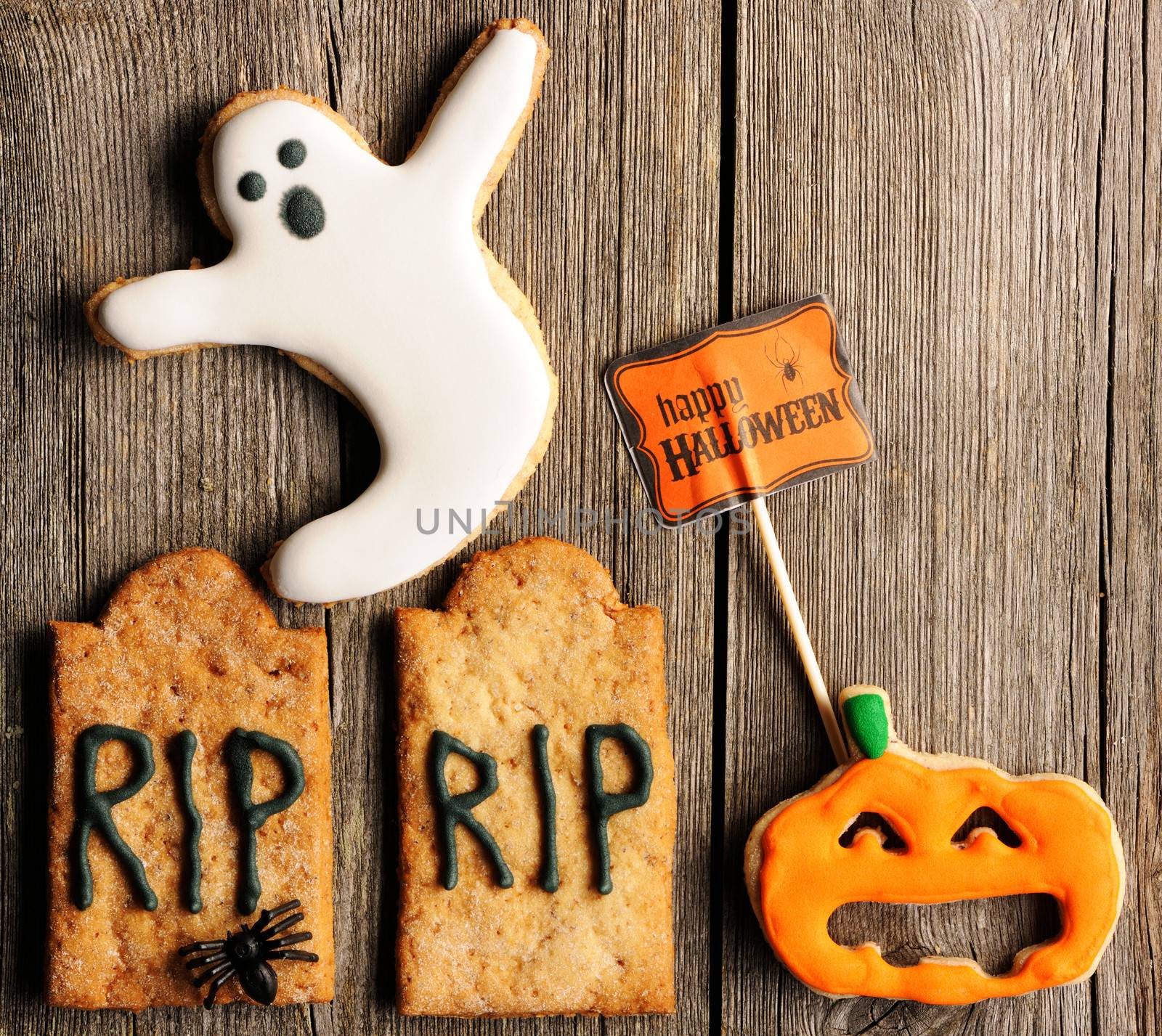 Halloween homemade gingerbread cookies over wooden table