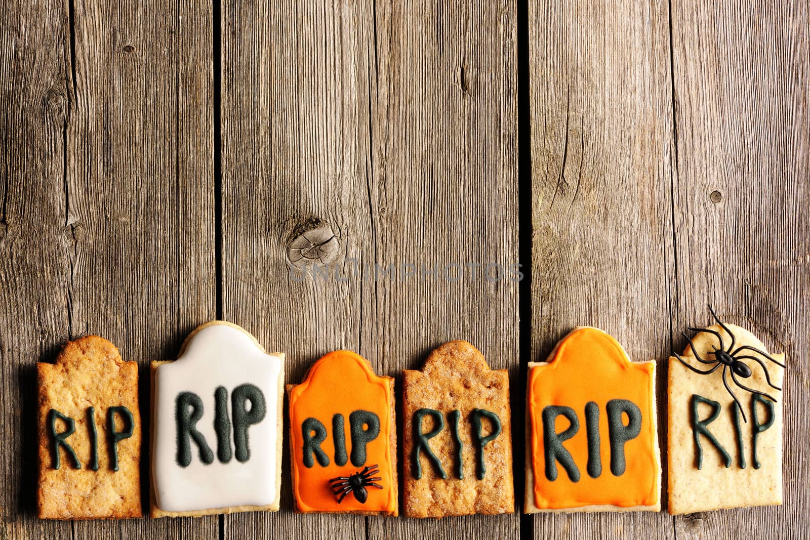 Halloween homemade gingerbread cookies over wooden table