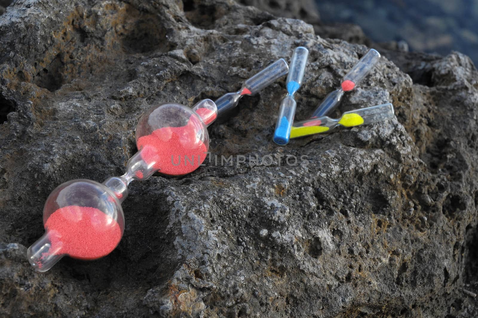 Time Concept - Hourglass Abandoned on the Volcanic Rocks