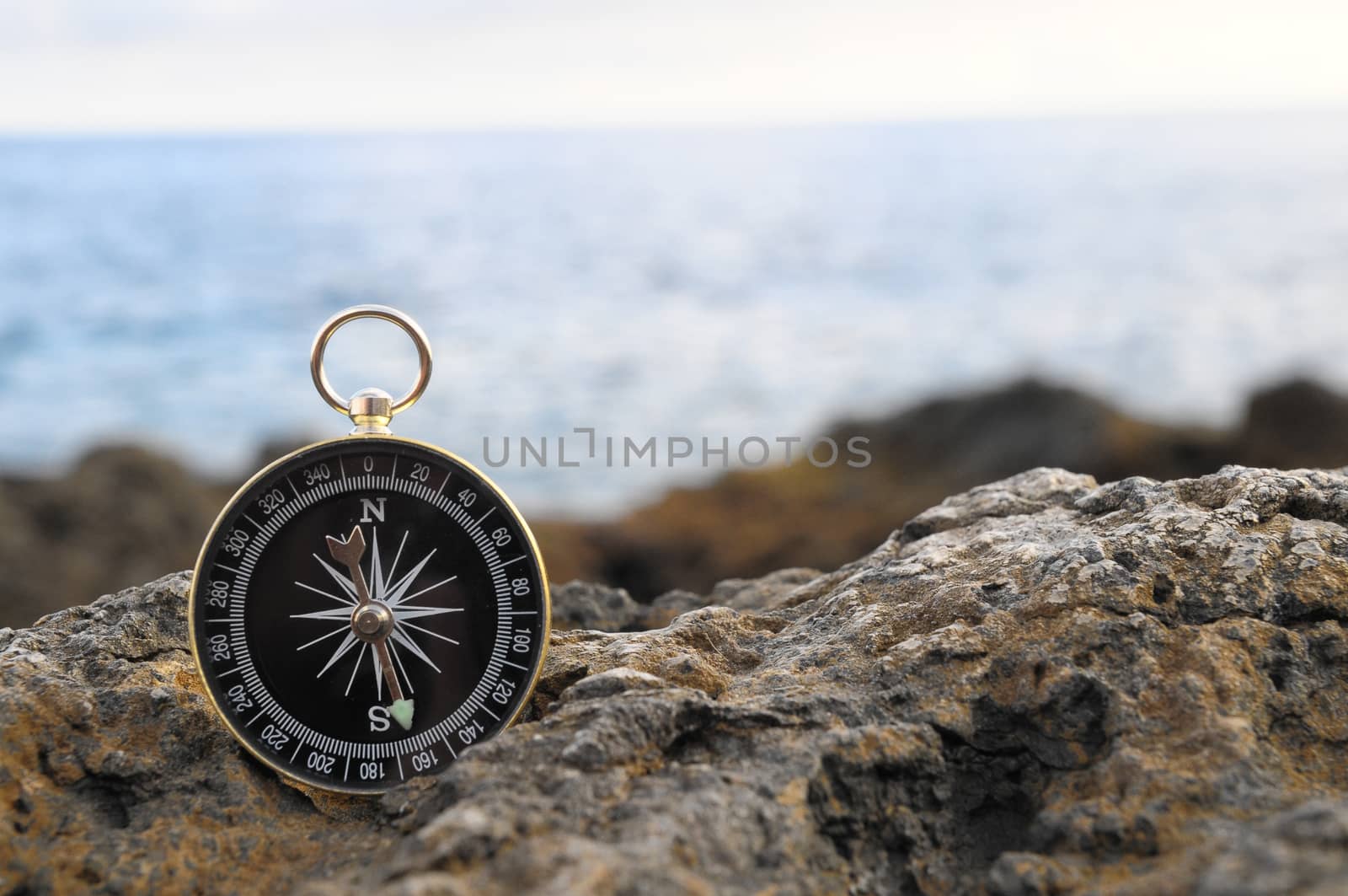 Orientation Concept - Analogic Compass Abandoned on the Rocks