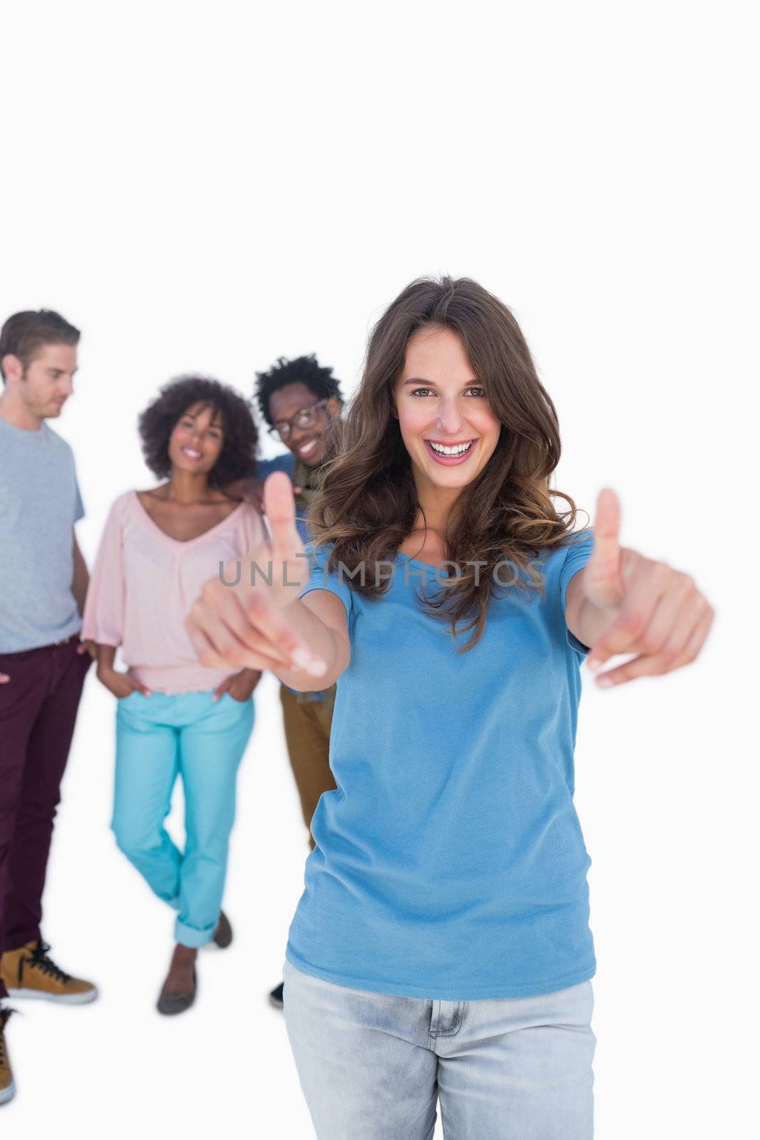 Stylish woman with thumbs up standing in front of fashion people