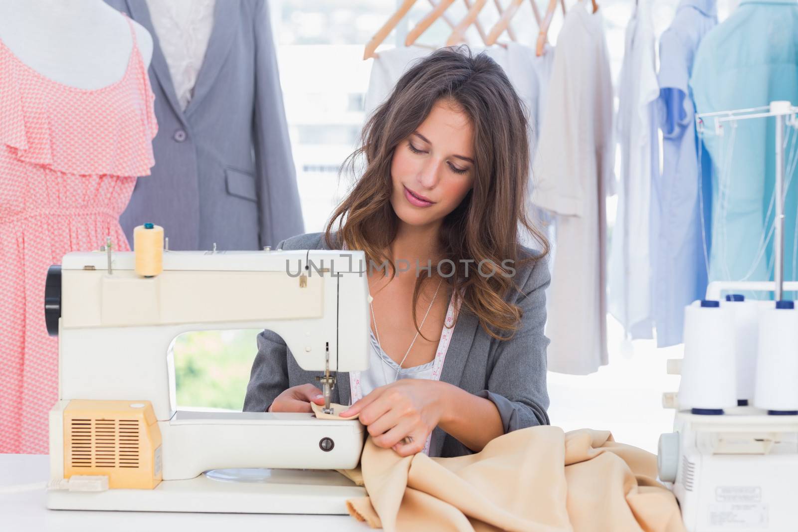Fashion designer sewing with sewing machine