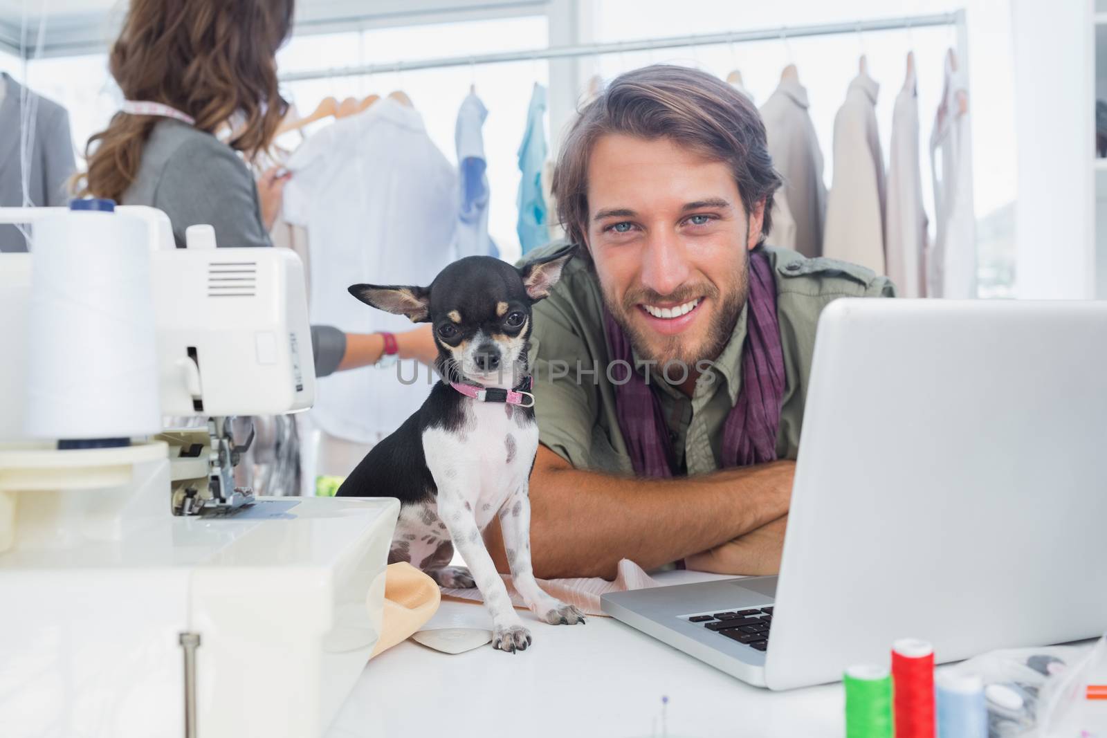 Smiling fashion designer with his chihuahua by Wavebreakmedia