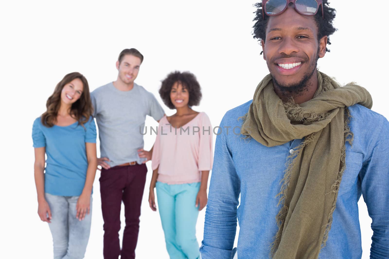 Fashion man standing in front of others young people against white background 