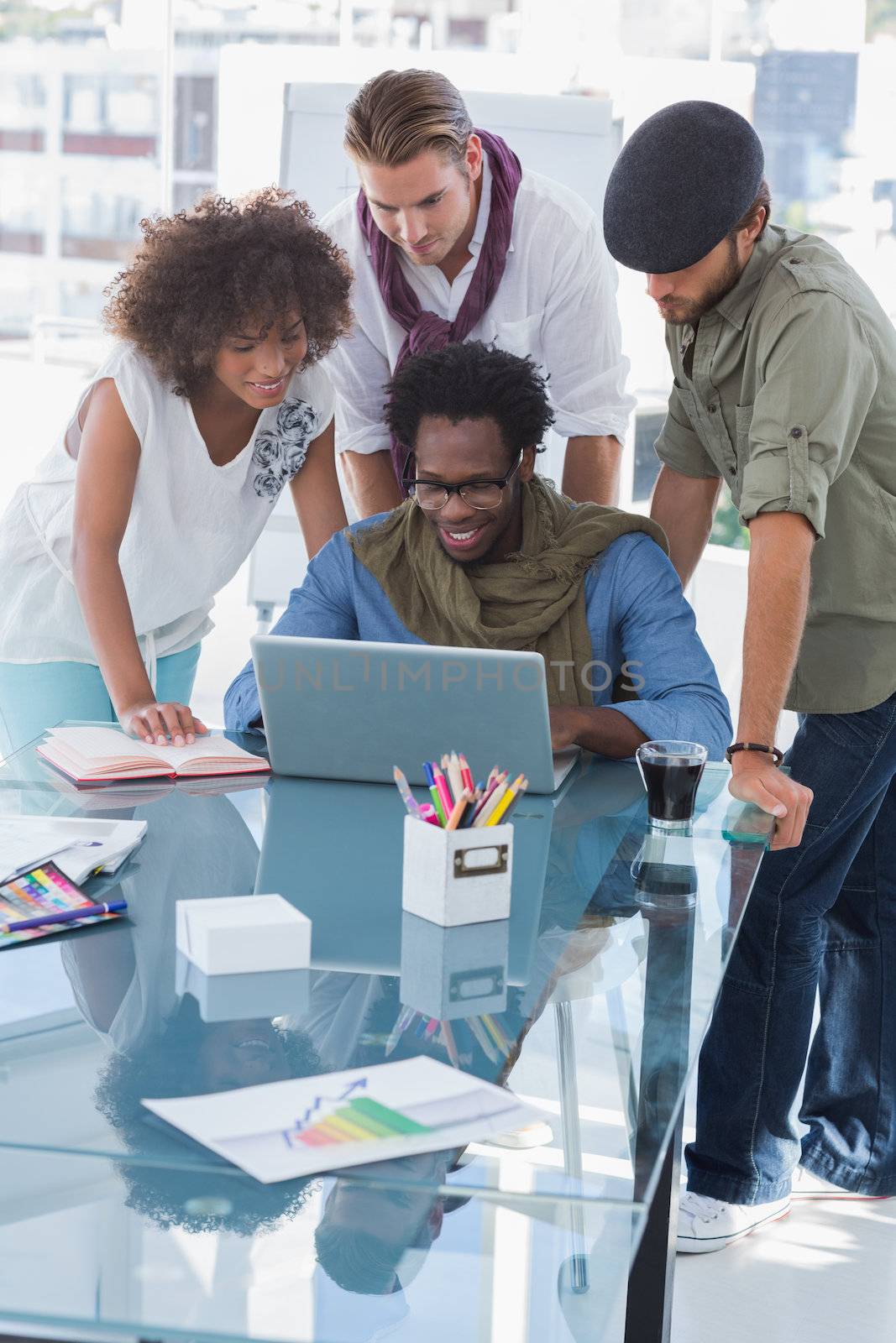 Team of young creative designers working on laptop