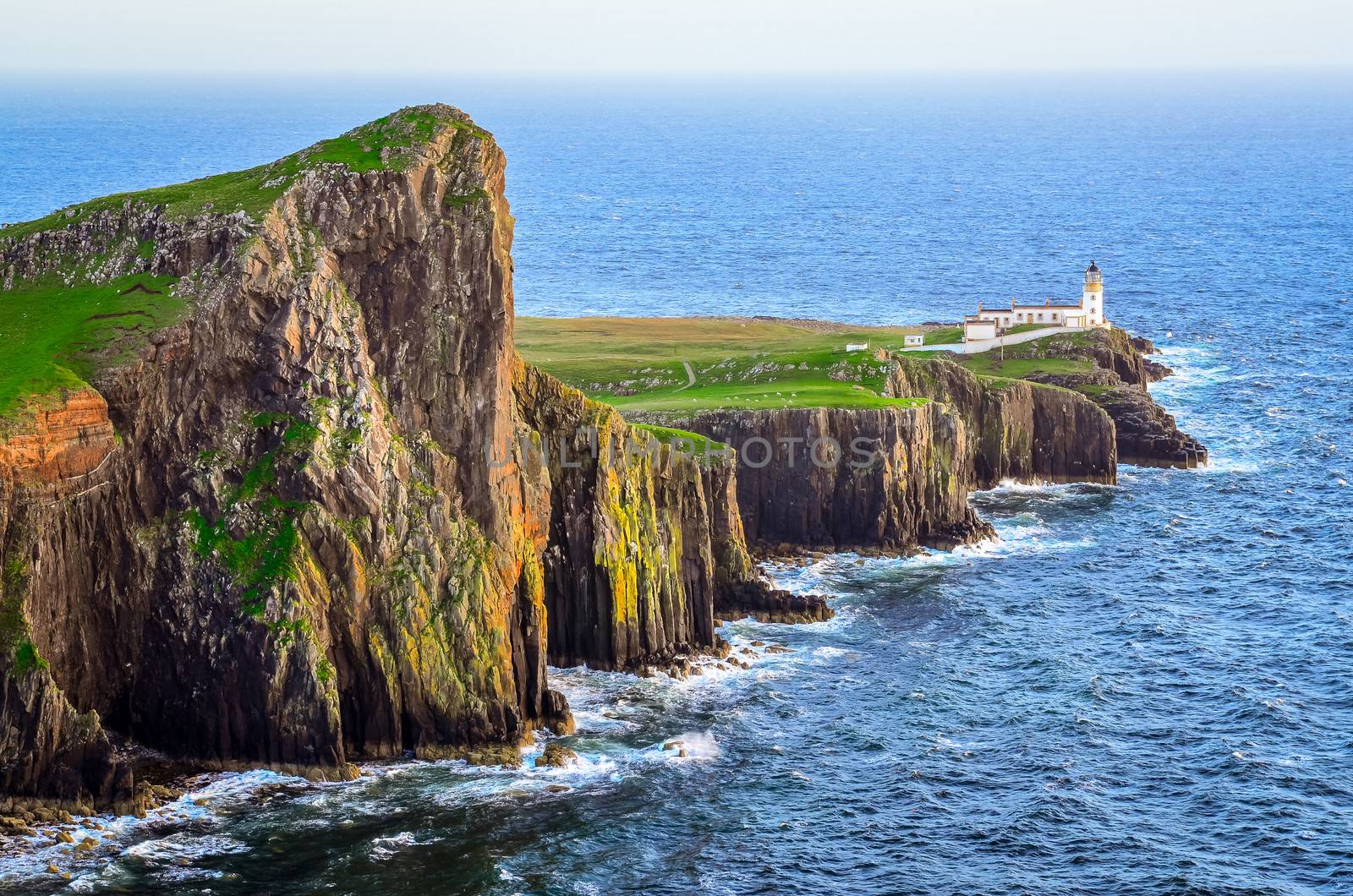 View of Neist Point lighthouse and rocky ocean coastline, Scotla by martinm303