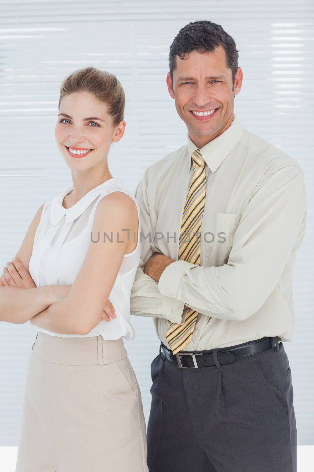 Business people smiling with arms crossed by Wavebreakmedia