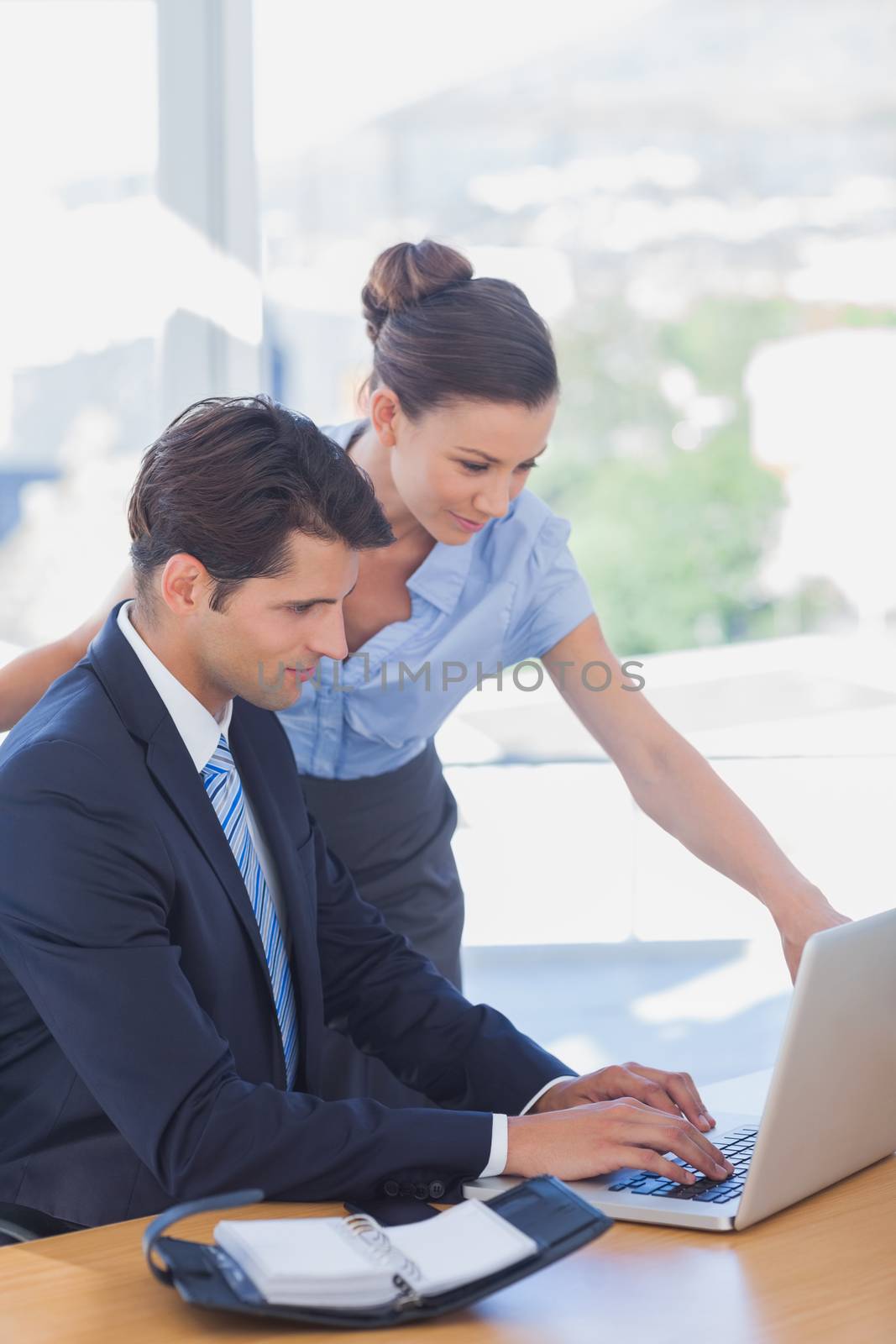 Business people working together with a laptop in the office