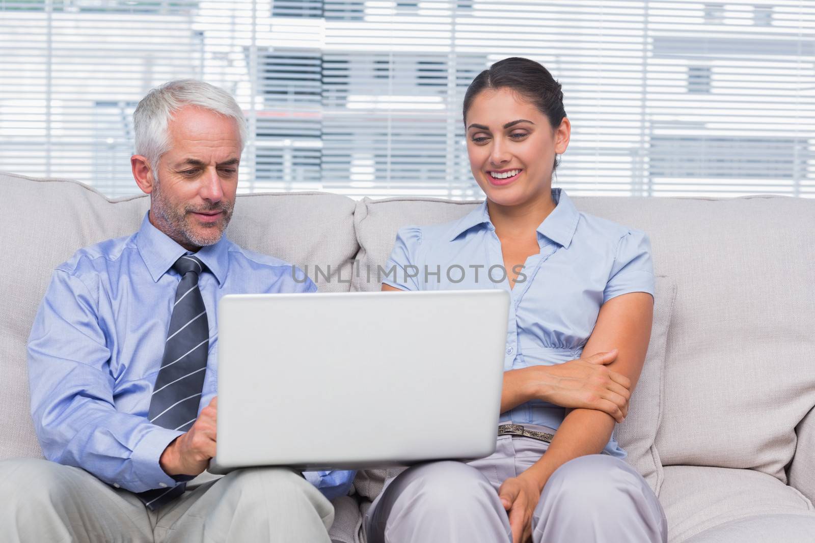 Business people looking at laptop  by Wavebreakmedia