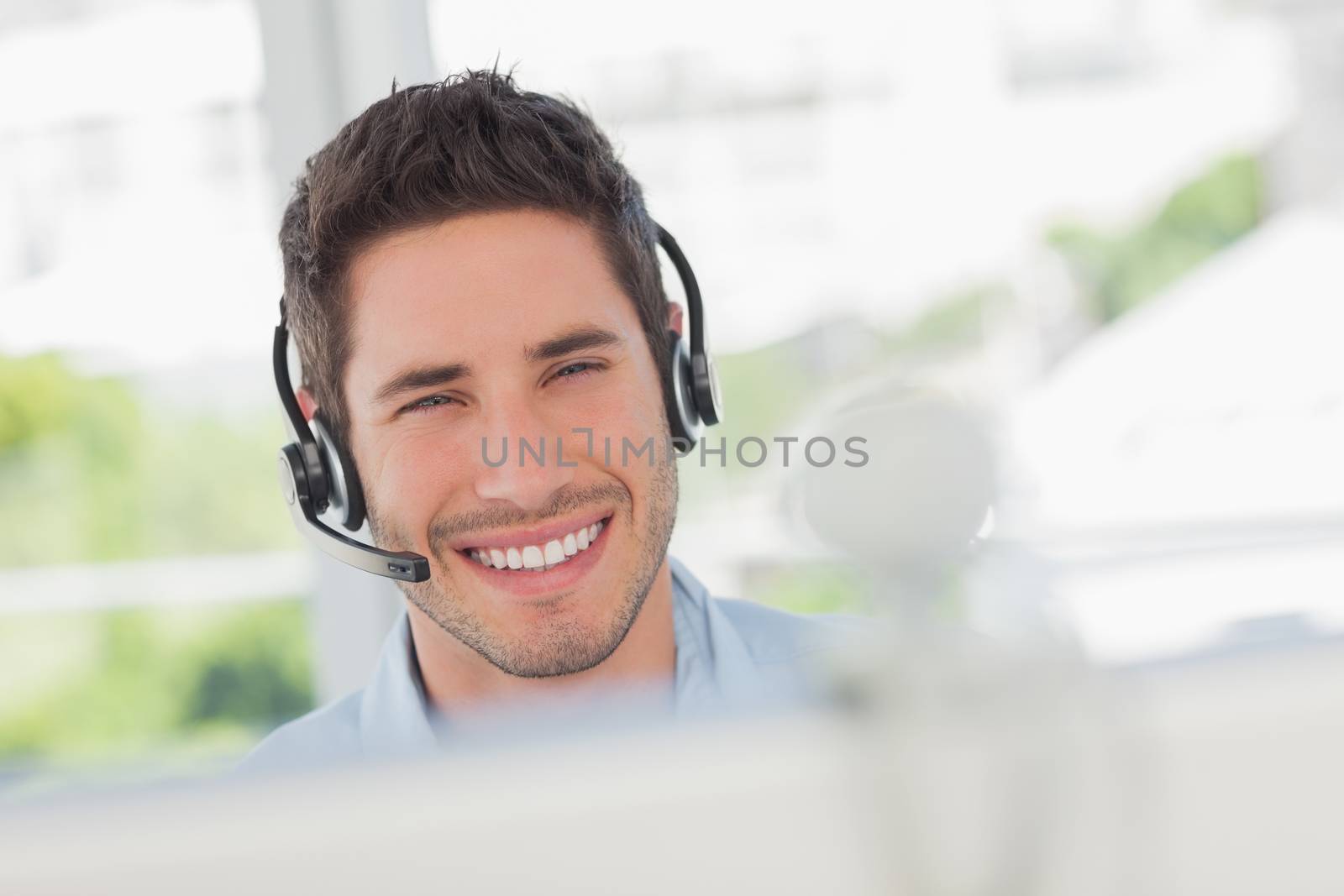 Happy designer having an online communication in his office