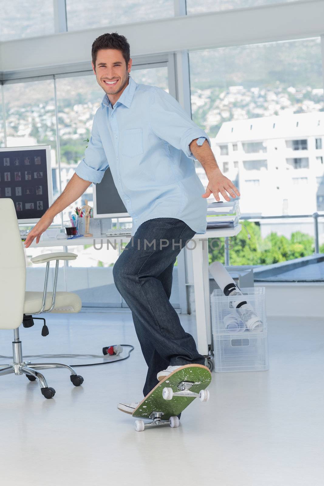 Creative designer skating in his office