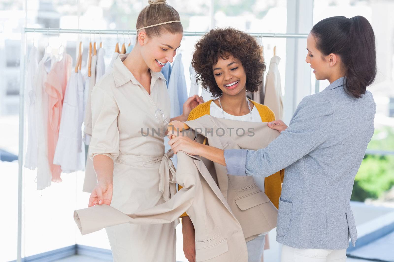 Fashion designers looking at a blazer in a studio