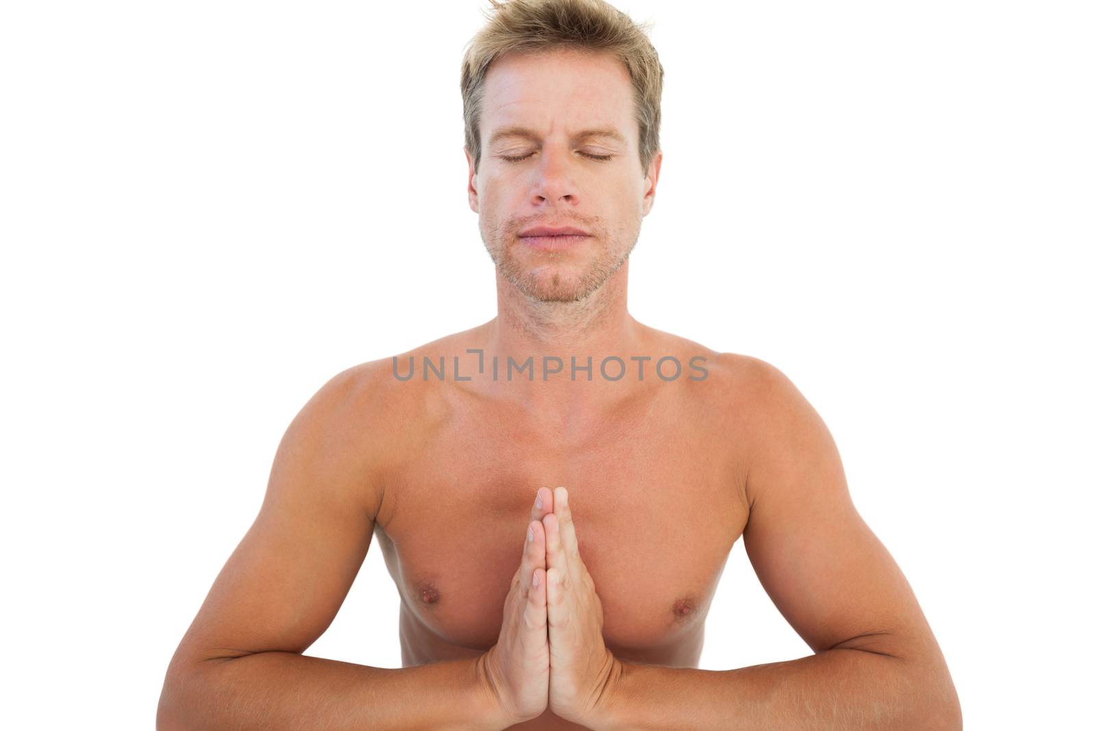 Man doing yoga and meditating on white background