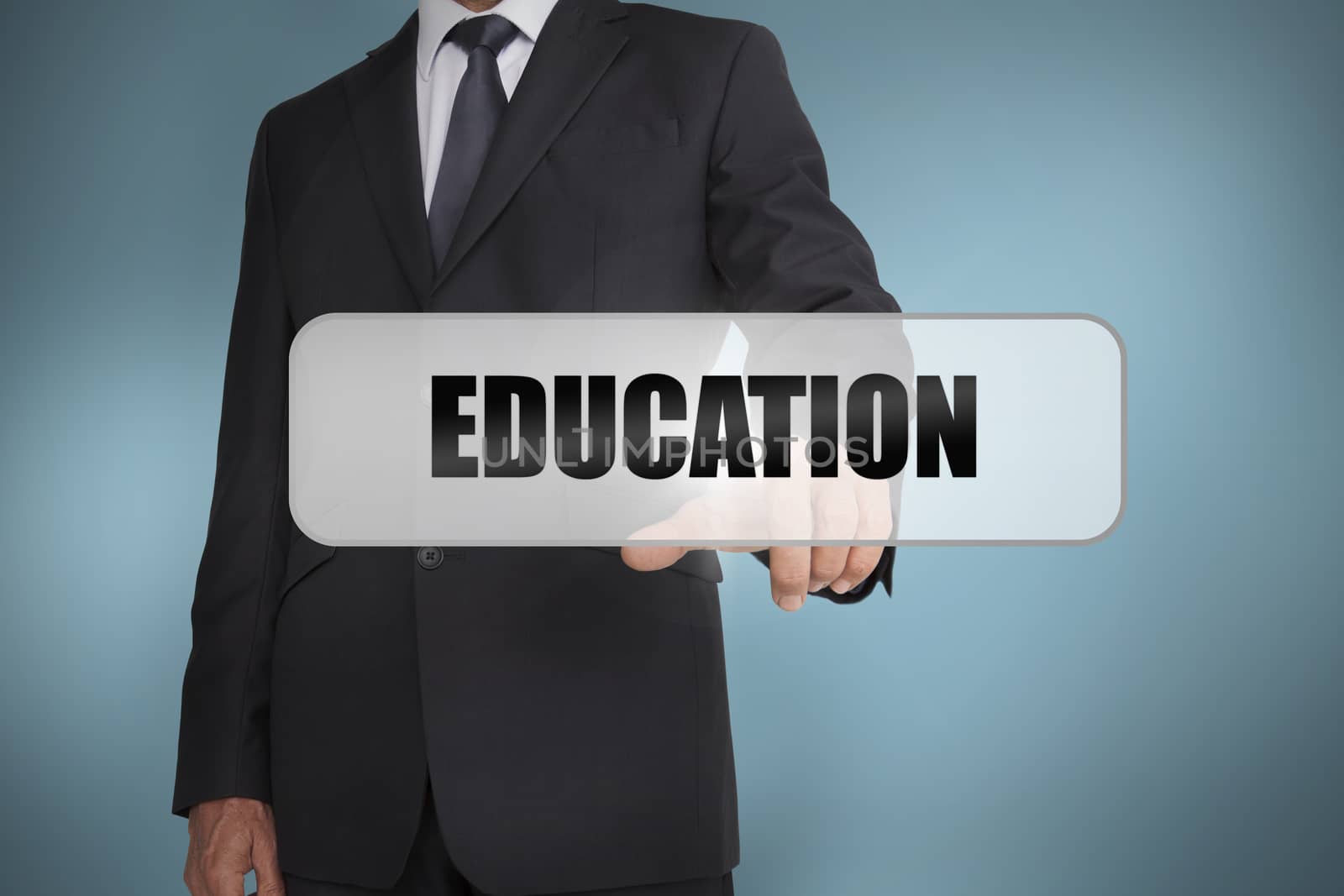 Businessman selecting the word education written on white tag by Wavebreakmedia