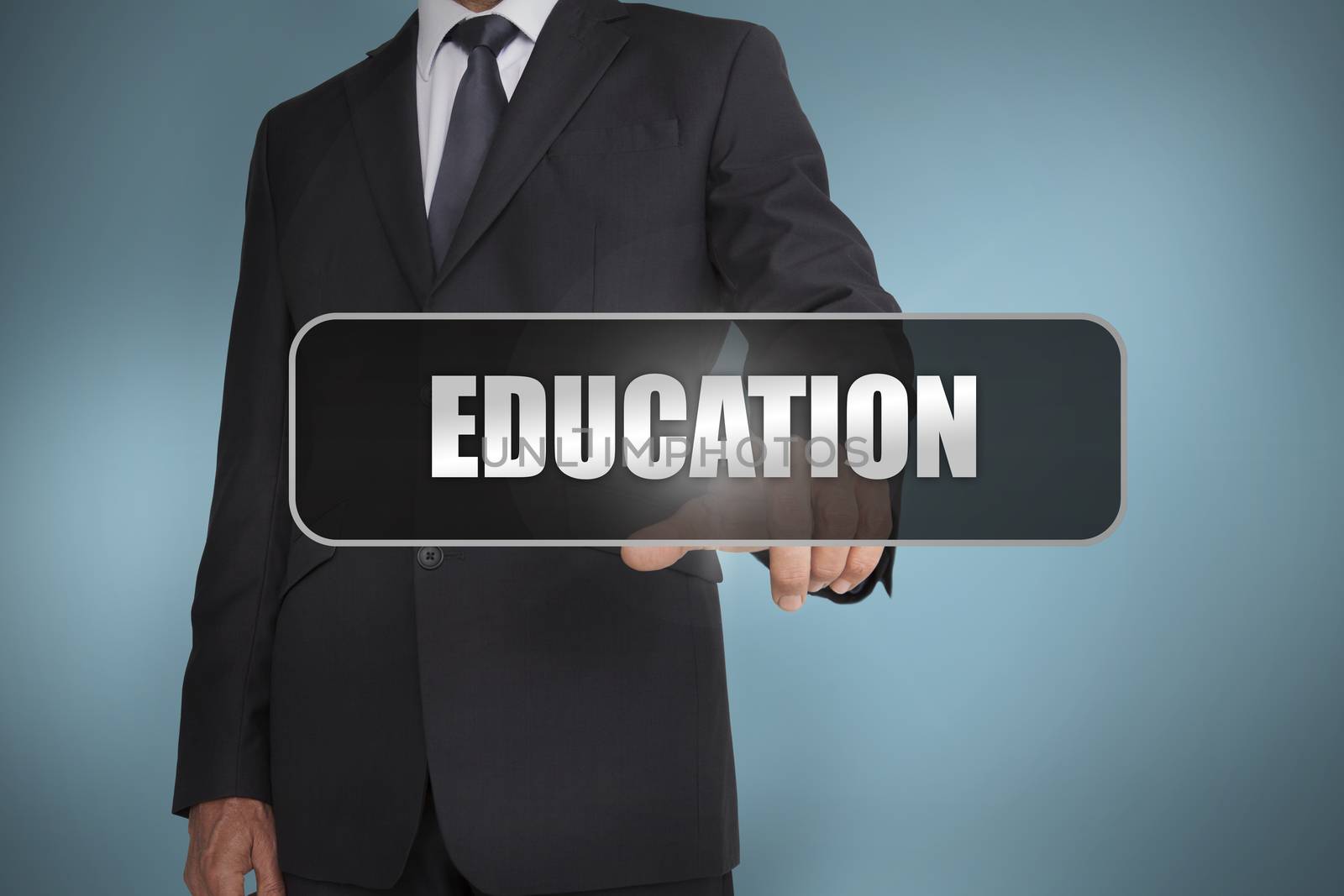 Businessman touching the word education written on black tag by Wavebreakmedia