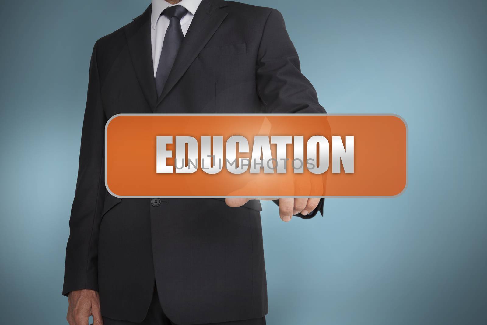 Businessman selecting the word education written on orange tag on blue background