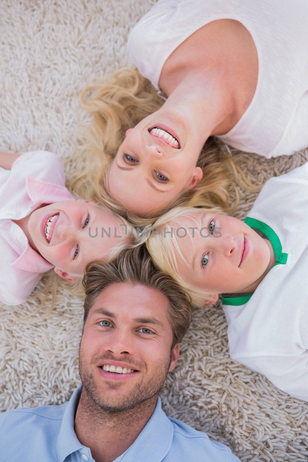 Family lying in a circle  by Wavebreakmedia